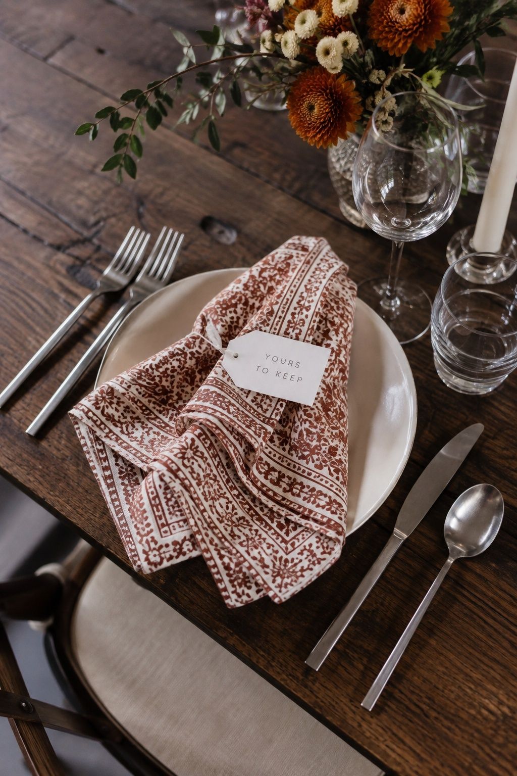Rust block-print napkin with a Yours to Keep favor tag