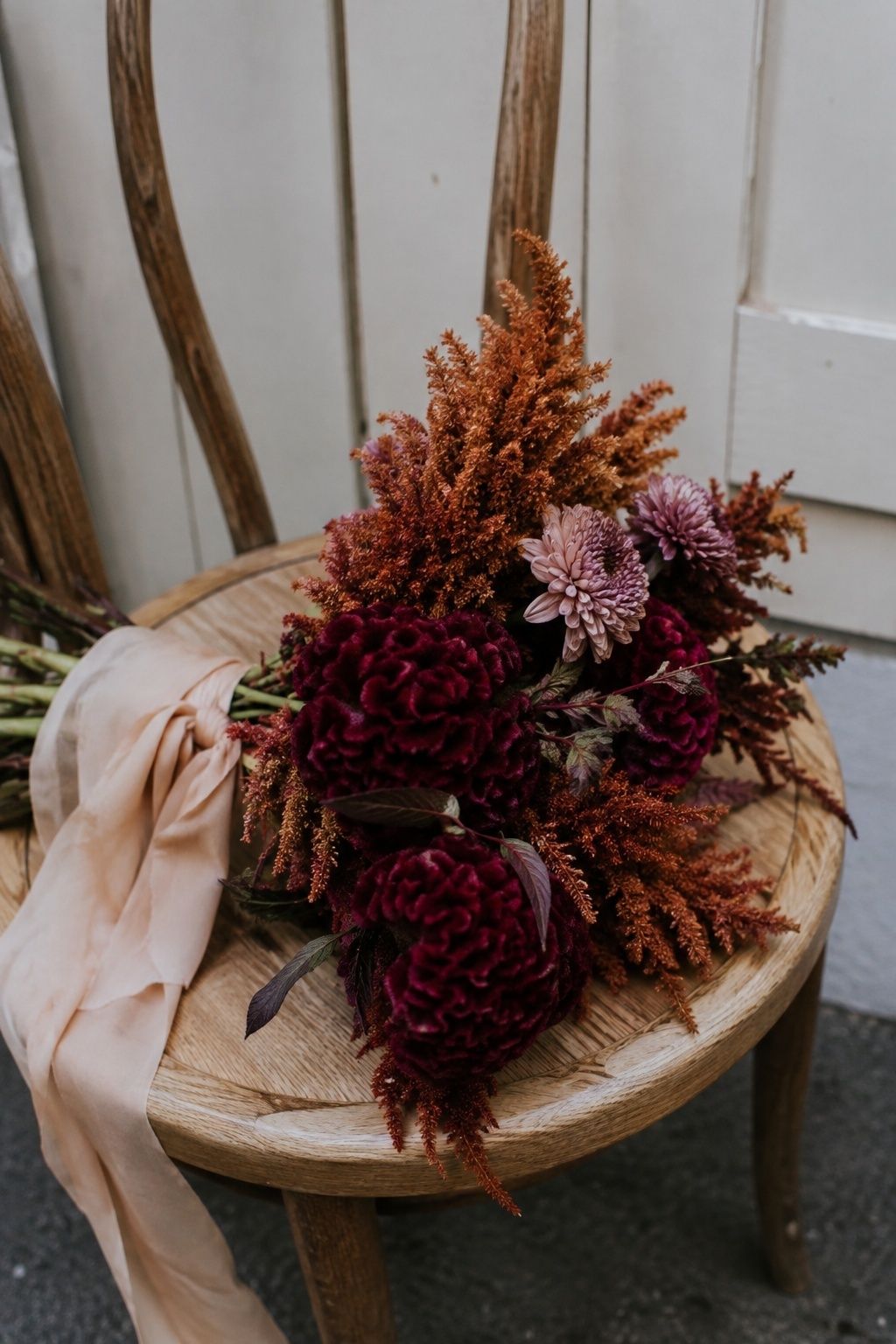 Burgundy and copper celosia in a bridal bouquet