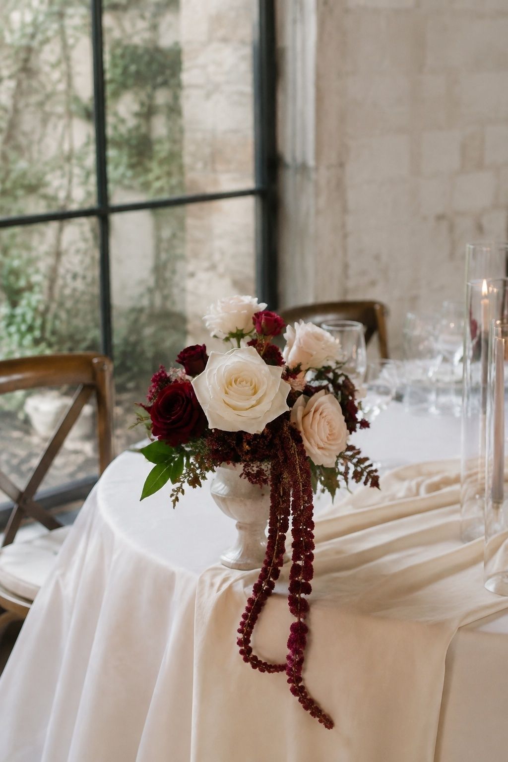 Two trailing amaranthus stems in a rose bouquet