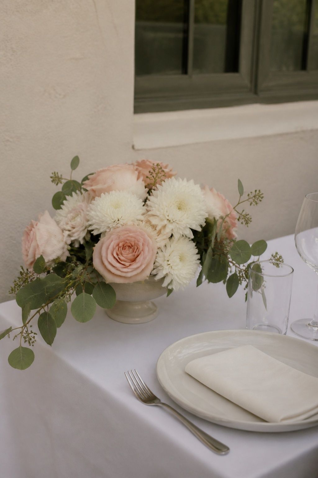 Seeded eucalyptus framing a blush and ivory compote
