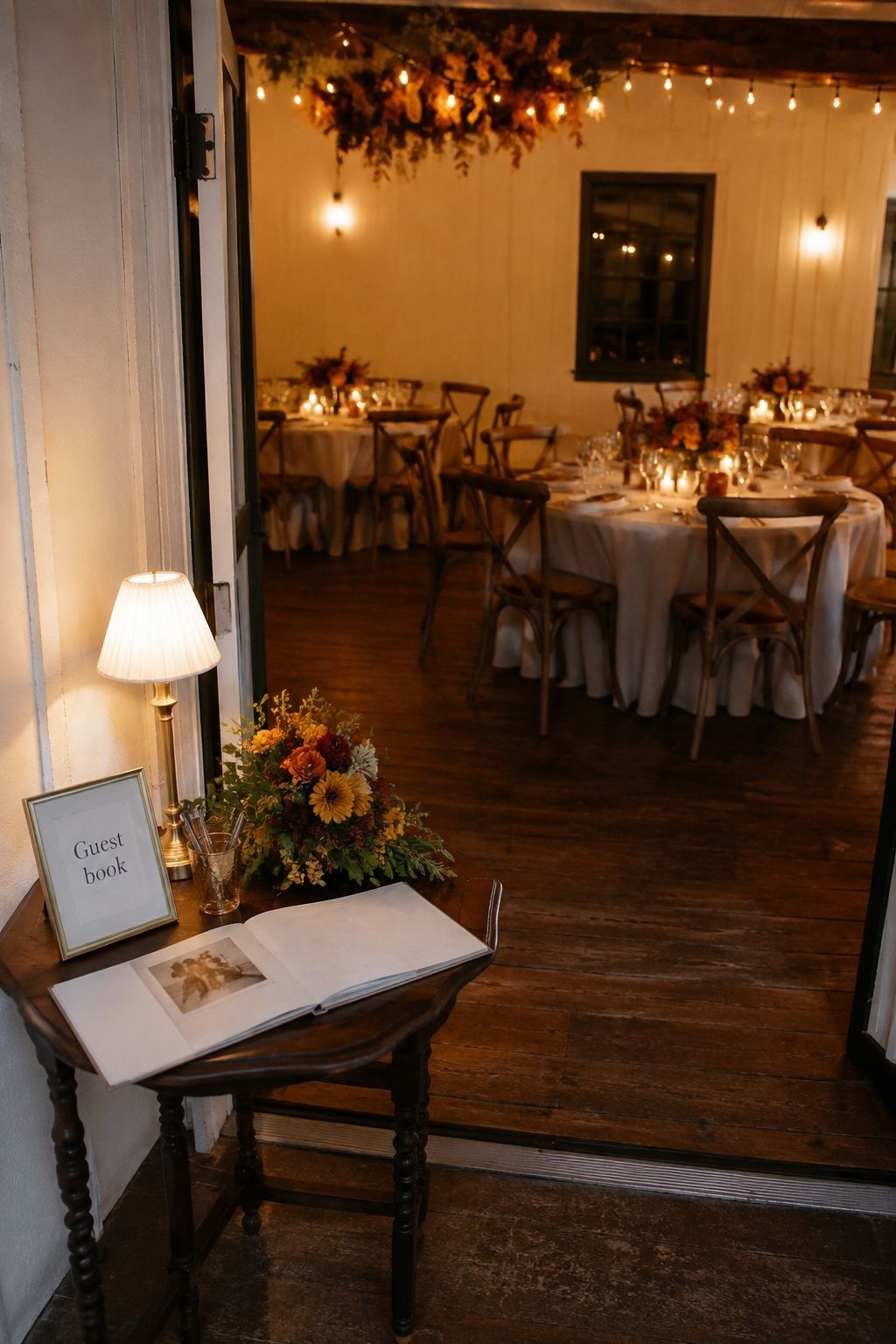 Guest book table beside the entrance to an intimate fall reception