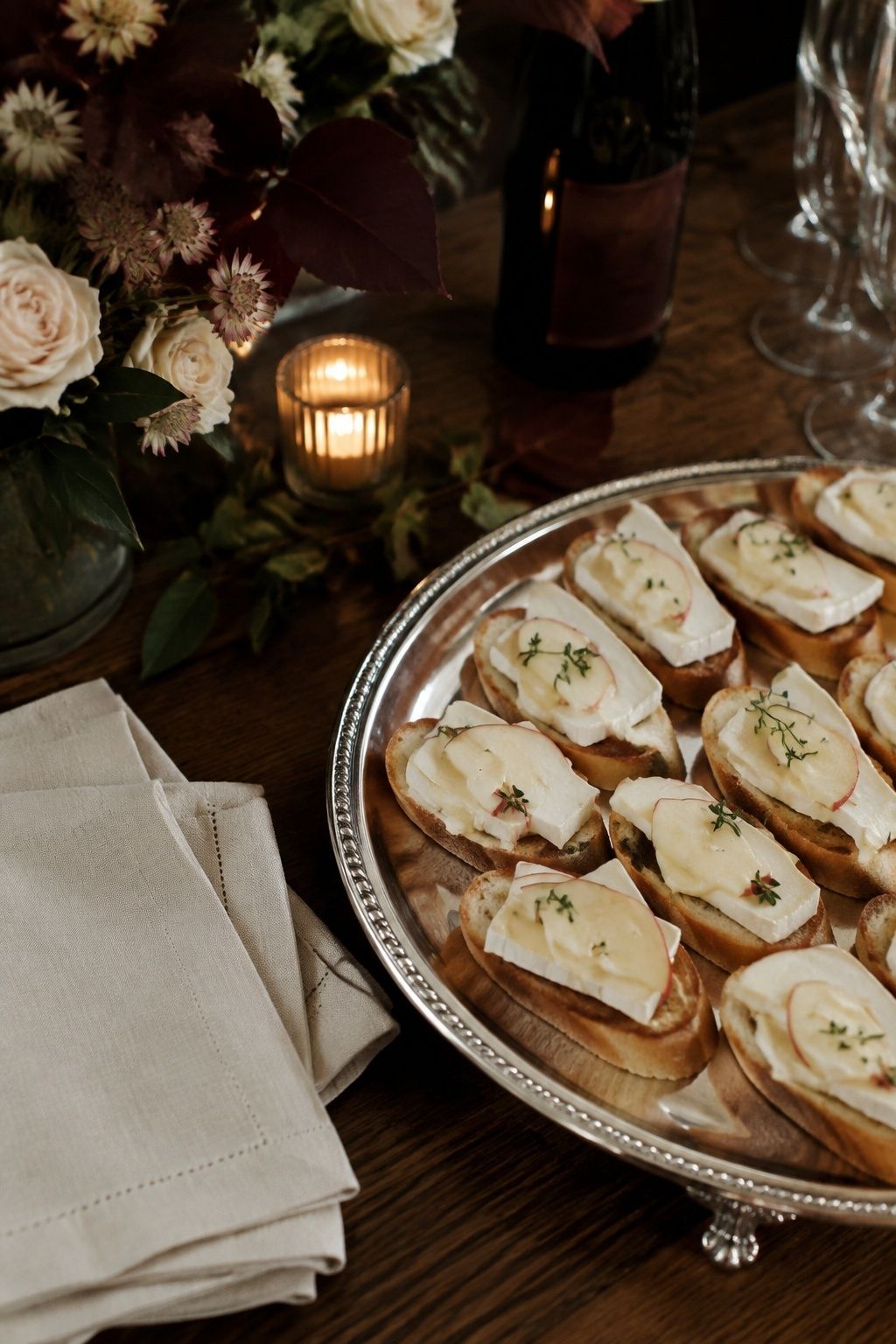Apple and brie crostini on a silver wedding cocktail-hour tray