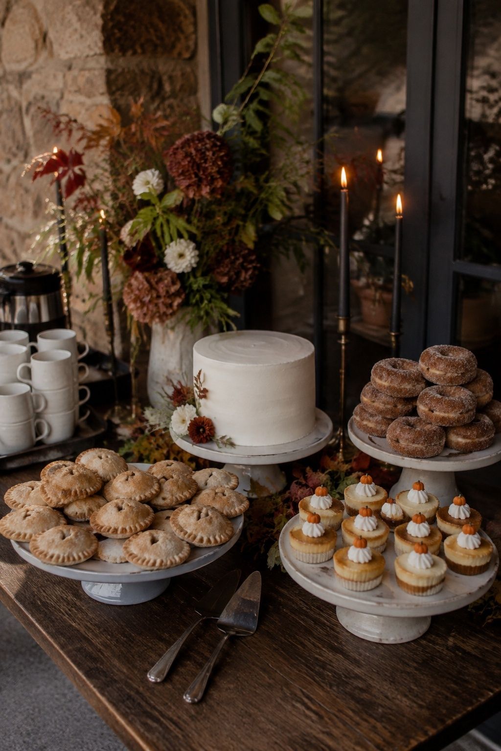 Fall wedding dessert table with a small cutting cake, hand pies and mini cheesecakes