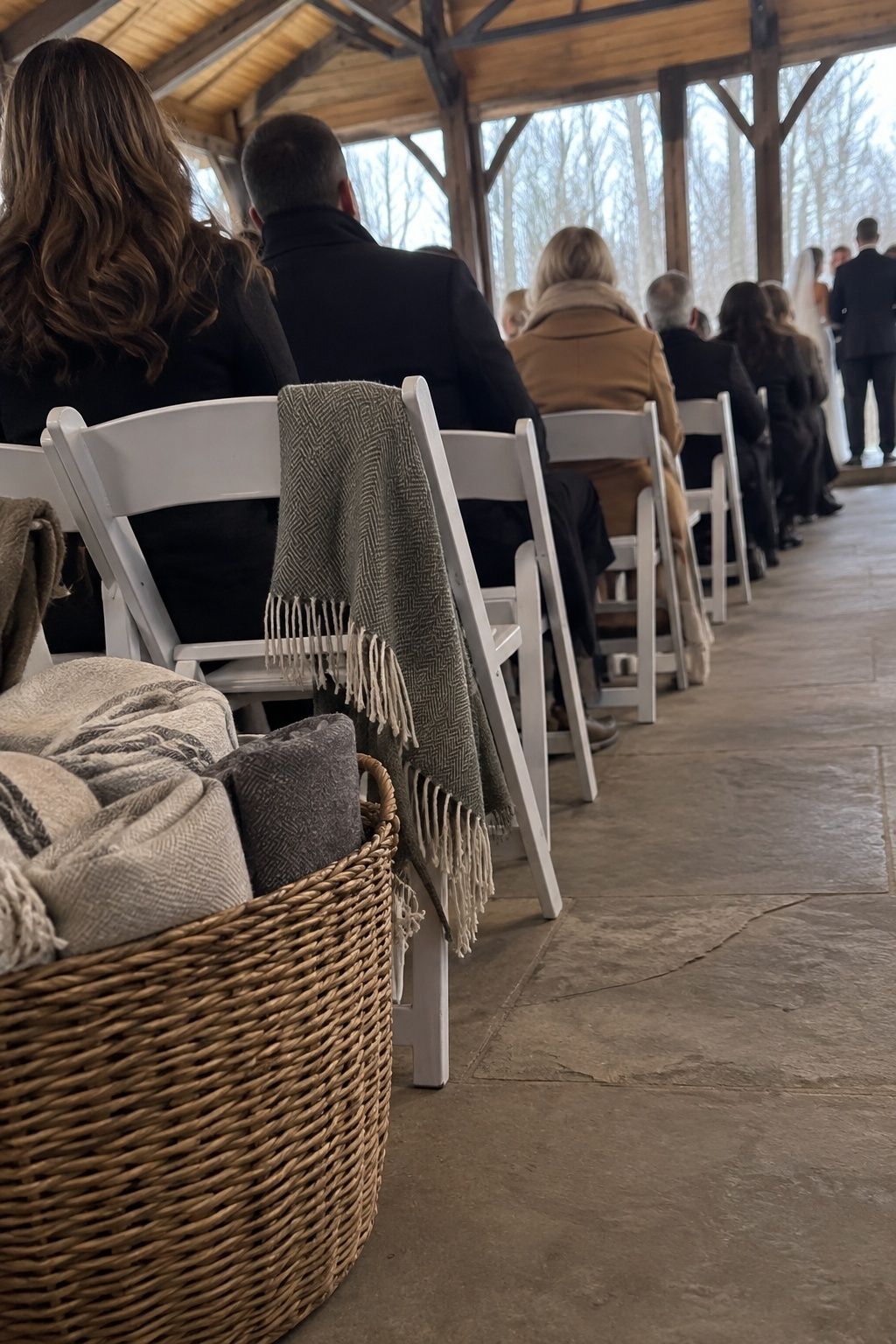 Wool blankets beside seated guests at a February wedding ceremony