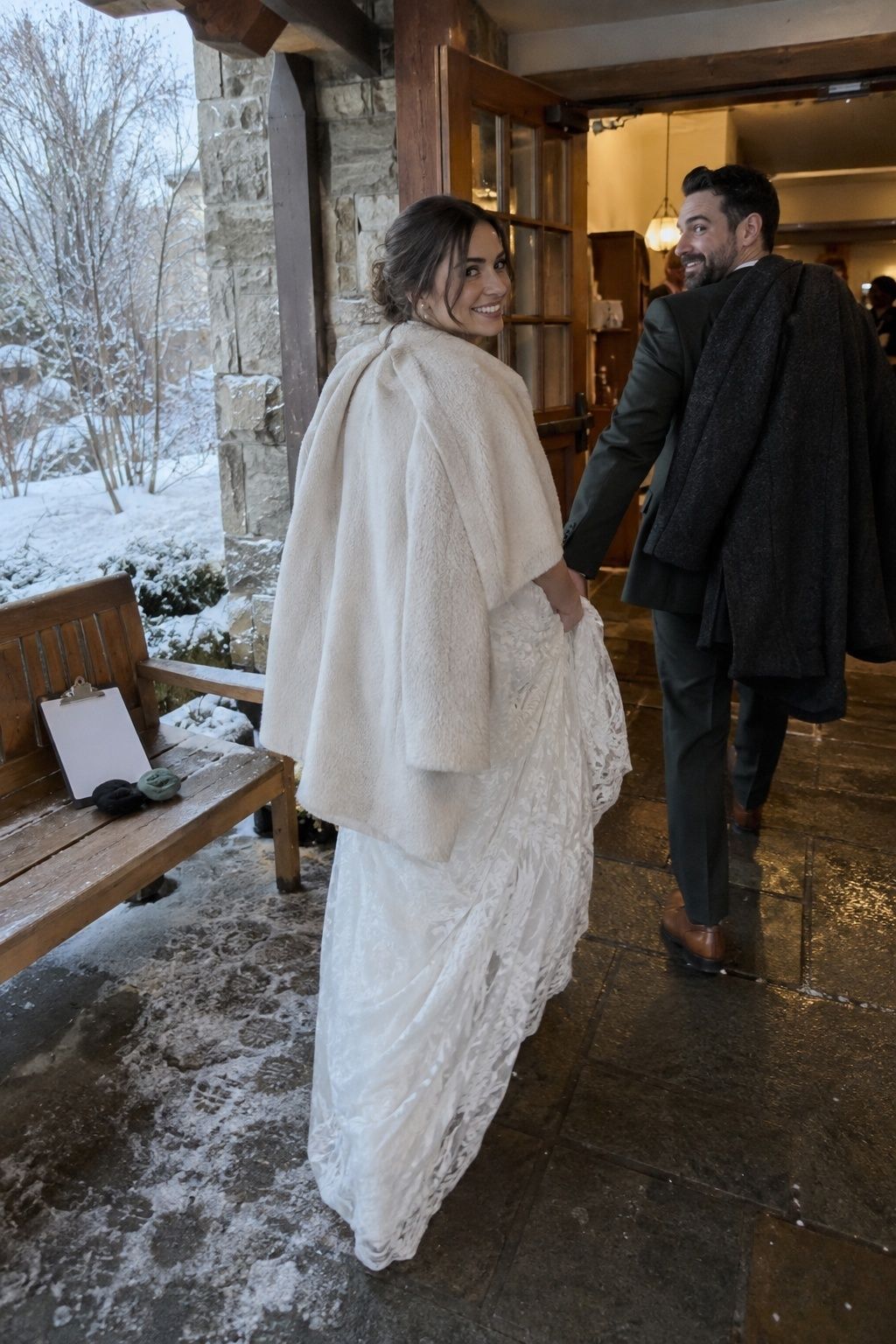Newlyweds warming indoors between February wedding portraits