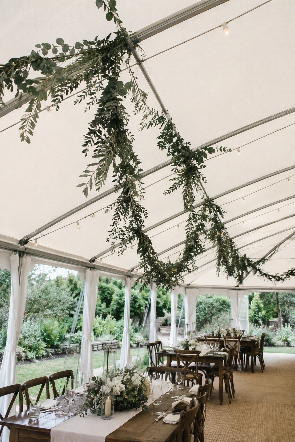 Suspended greenery across a tent ceiling
