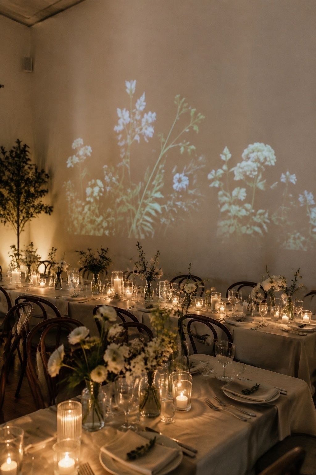 Dinner projection on a plain wall above an intimate wedding table