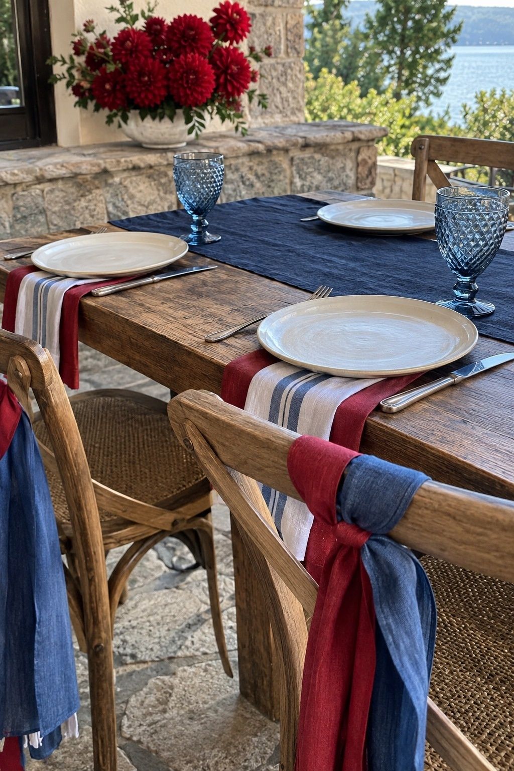 Red, white and blue linen table setting at a lakeside wedding