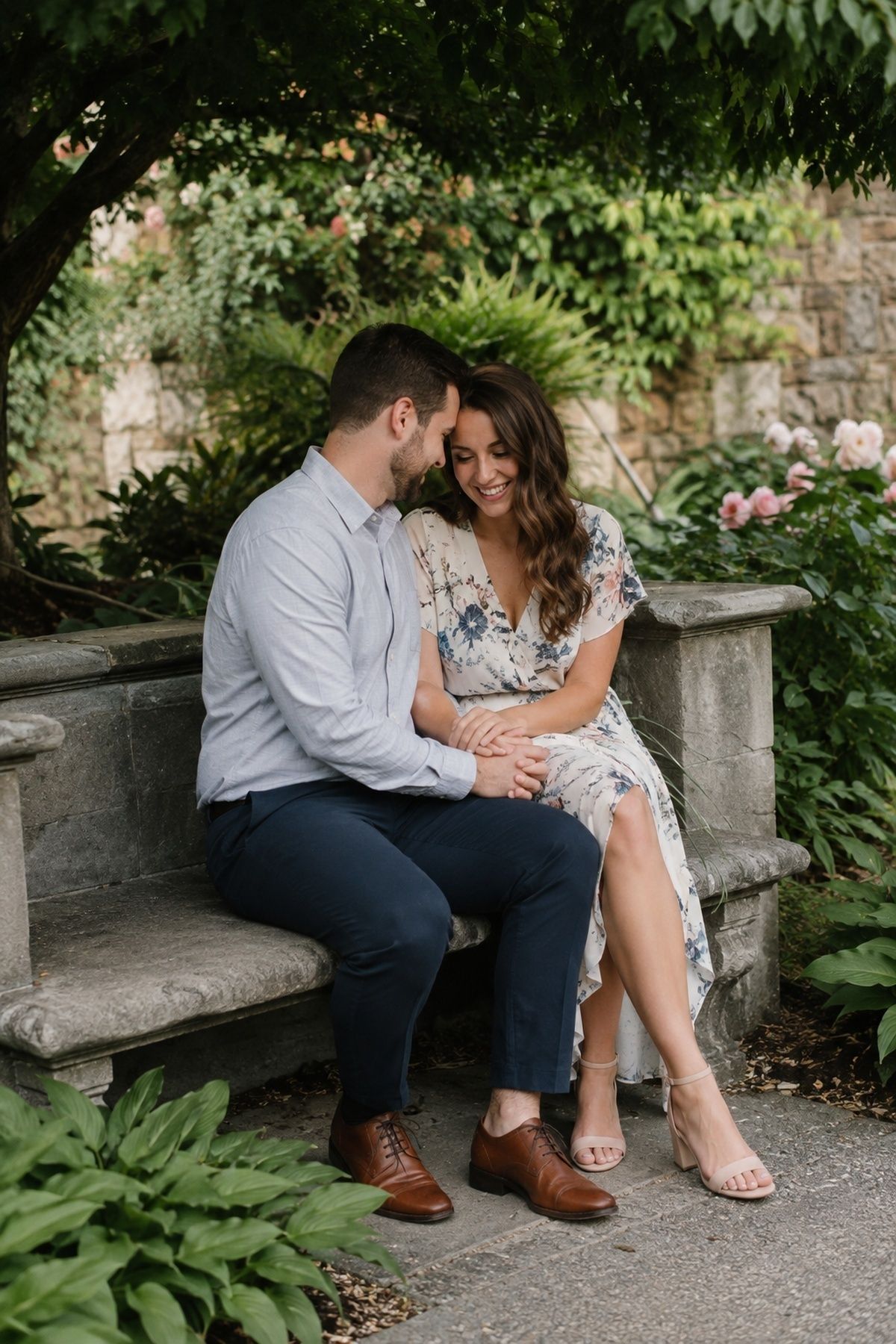Couple sitting on a garden bench or low stone wall
