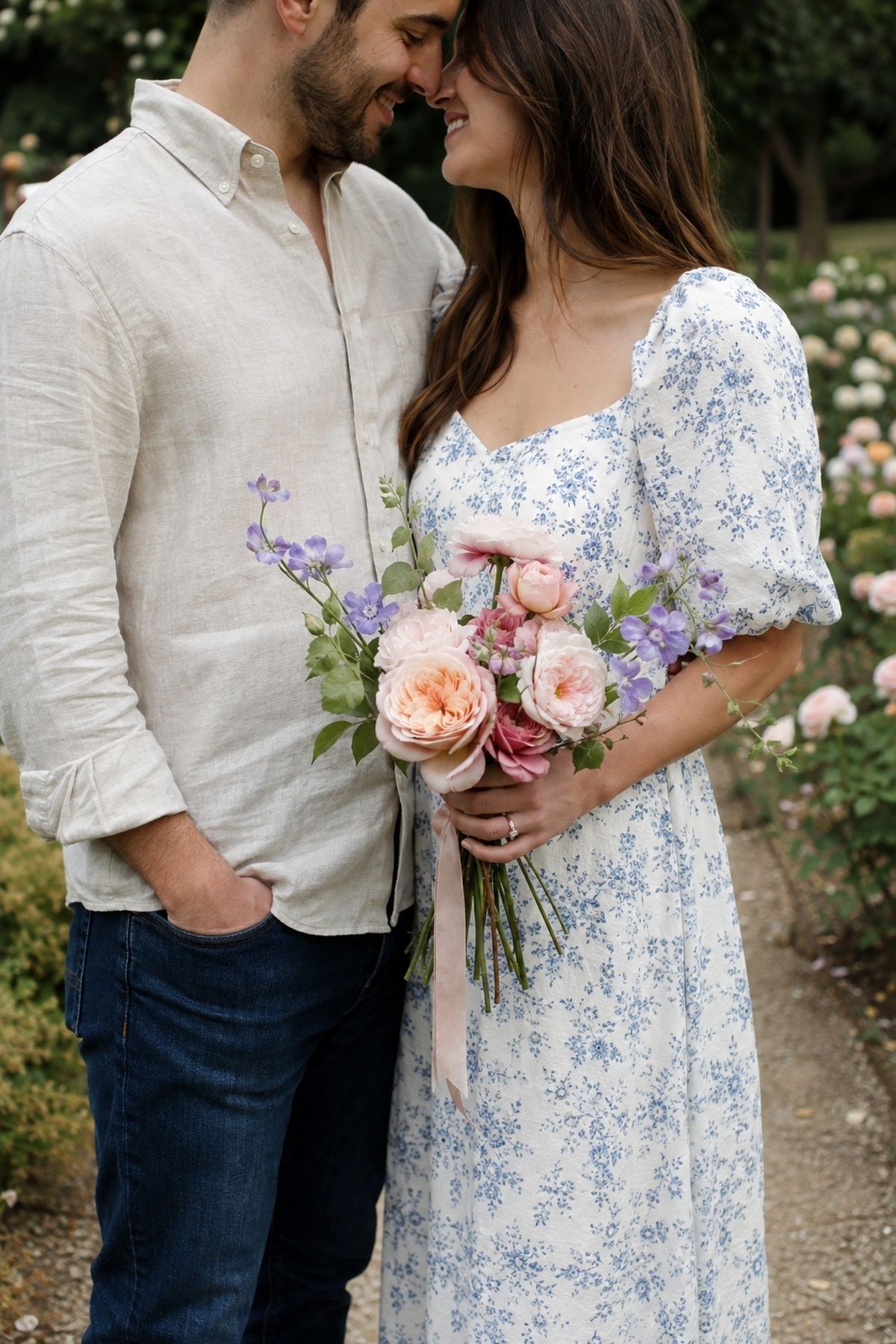 Couple holding a single bouquet or flower stem