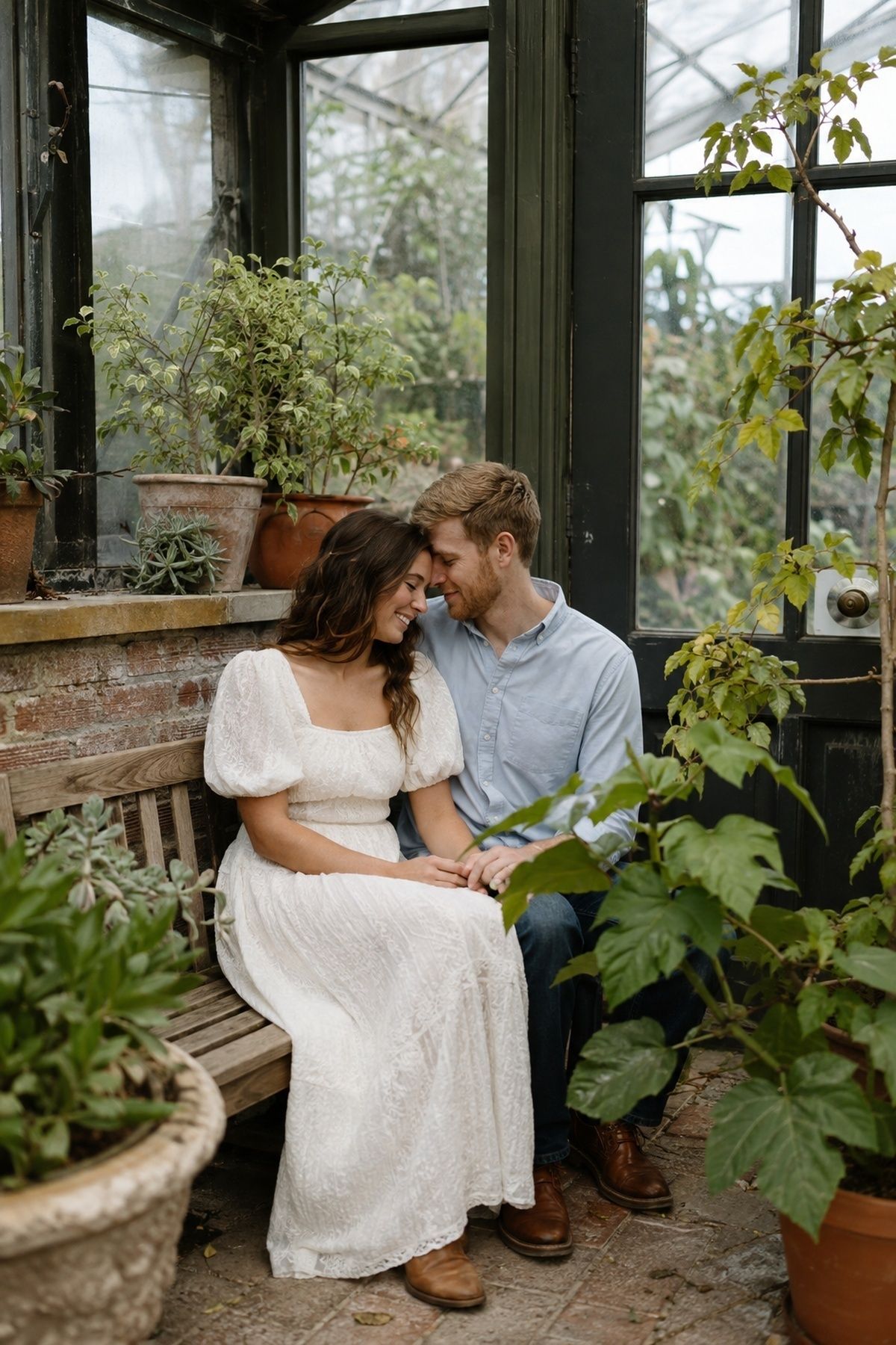 Engagement photo in a greenhouse corner