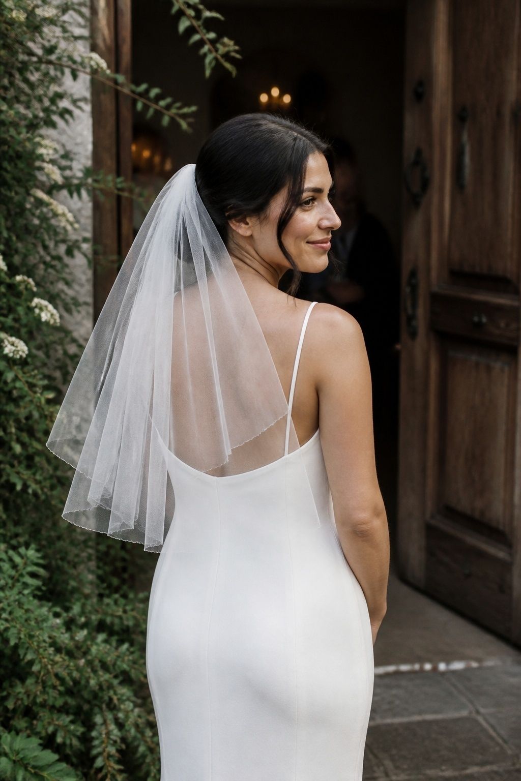 Short airy veil over a minimalist ivory bridal dress