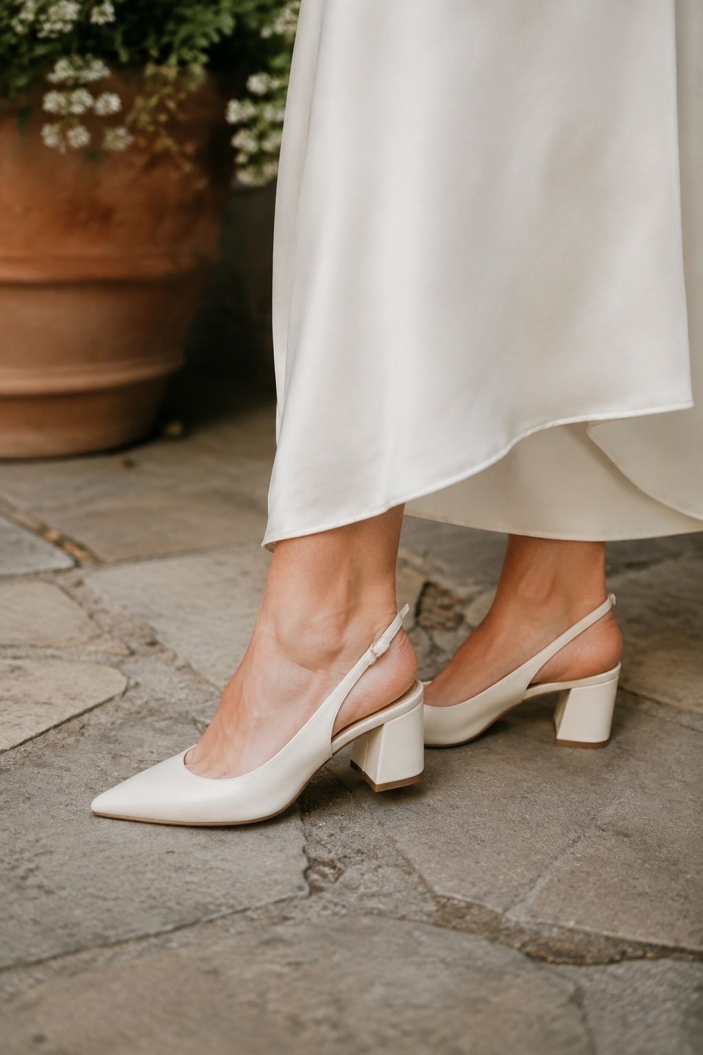 Ivory slingback block heels beneath a simple wedding dress hem