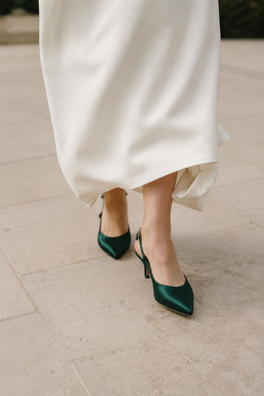 Emerald satin pumps under a clean wedding gown