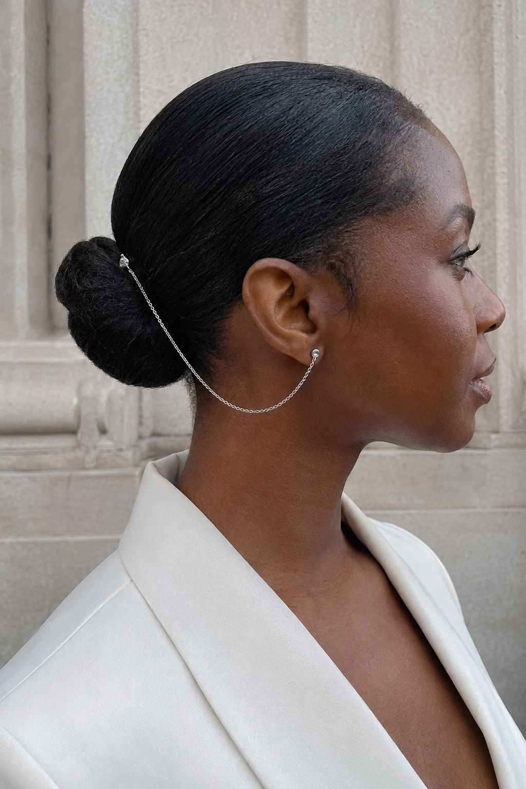 Sleek chignon with a silver hair chain