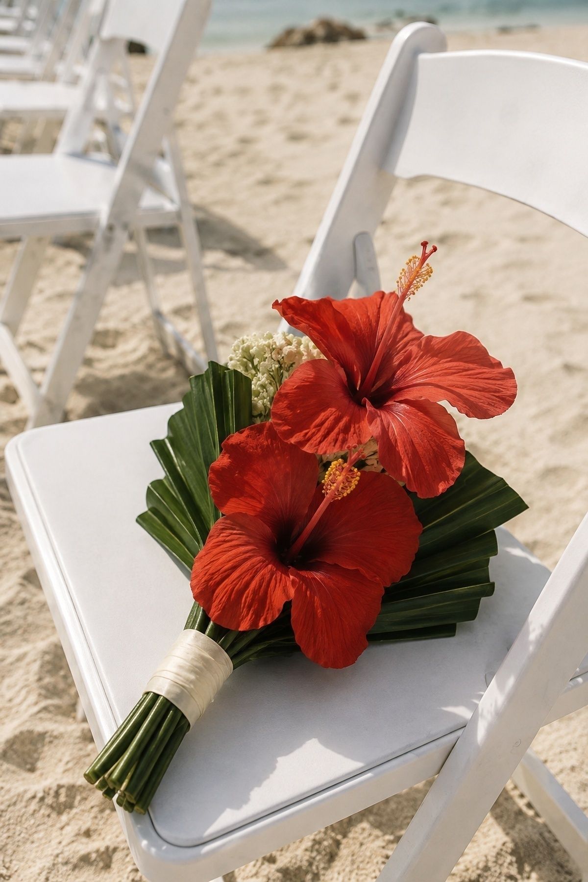 Red hibiscus bouquet with palm leaves