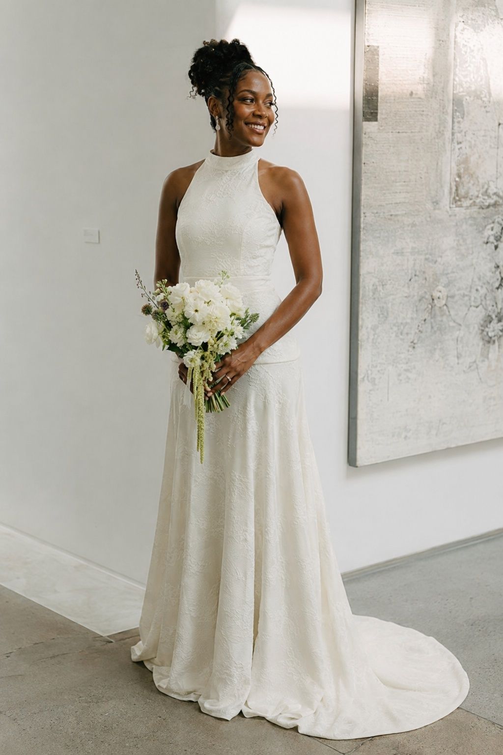 Full-length adult tall Black bride in ivory high neck wedding gown with a soft low mock collar and unmistakable horizontal drop waist seam at upper hip below natural waist