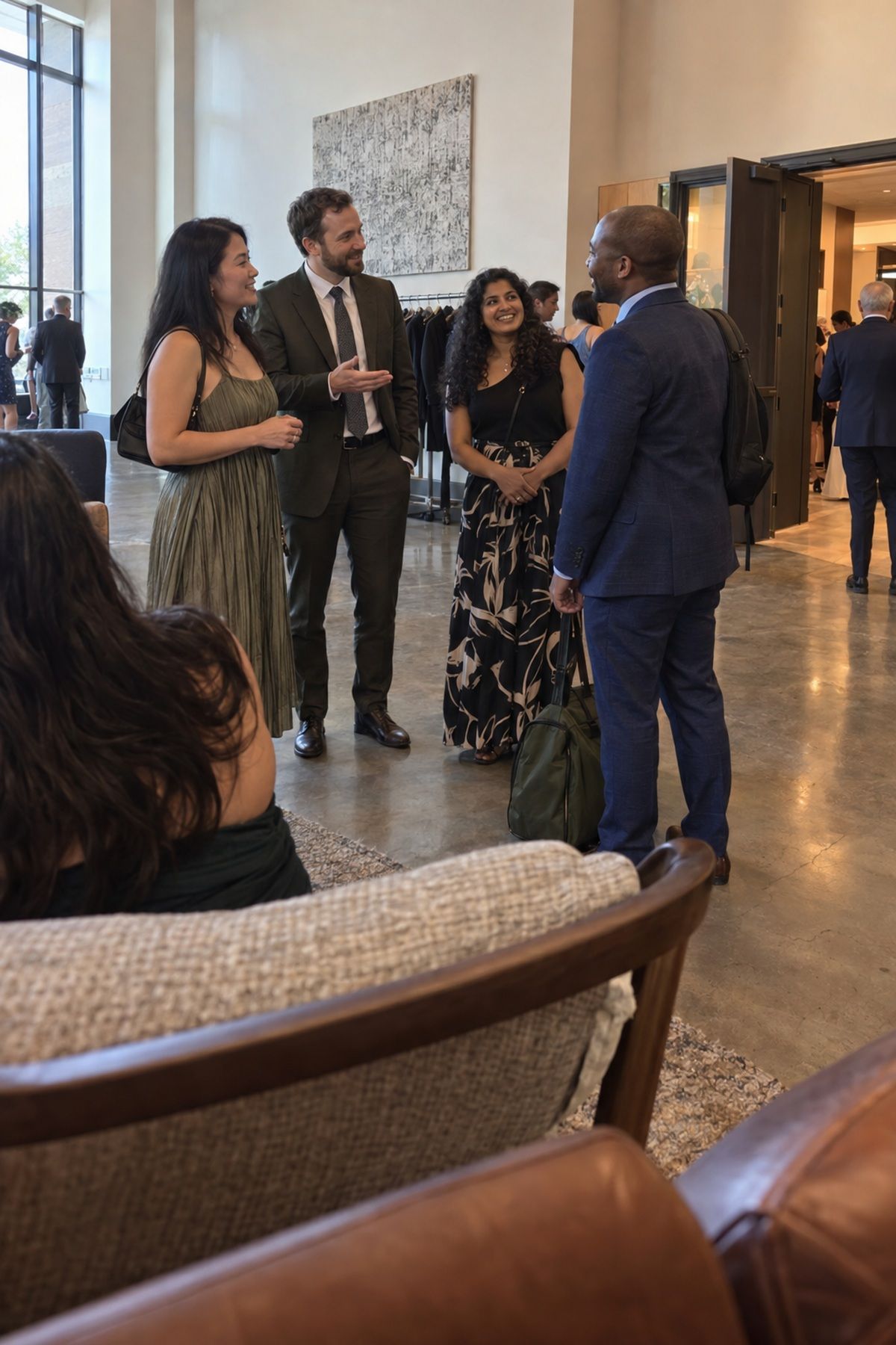 A host gently introduces a solo wedding guest during a relaxed reception transition.