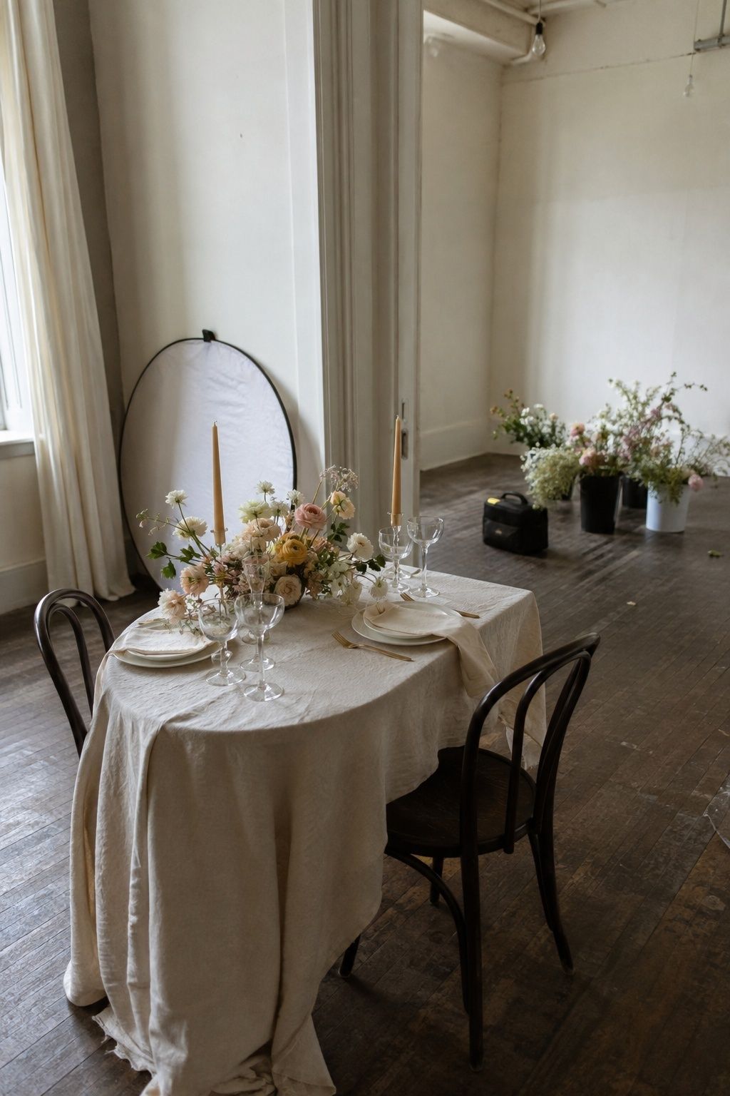 Perfect styled-shoot wedding table with production equipment visible in an empty studio