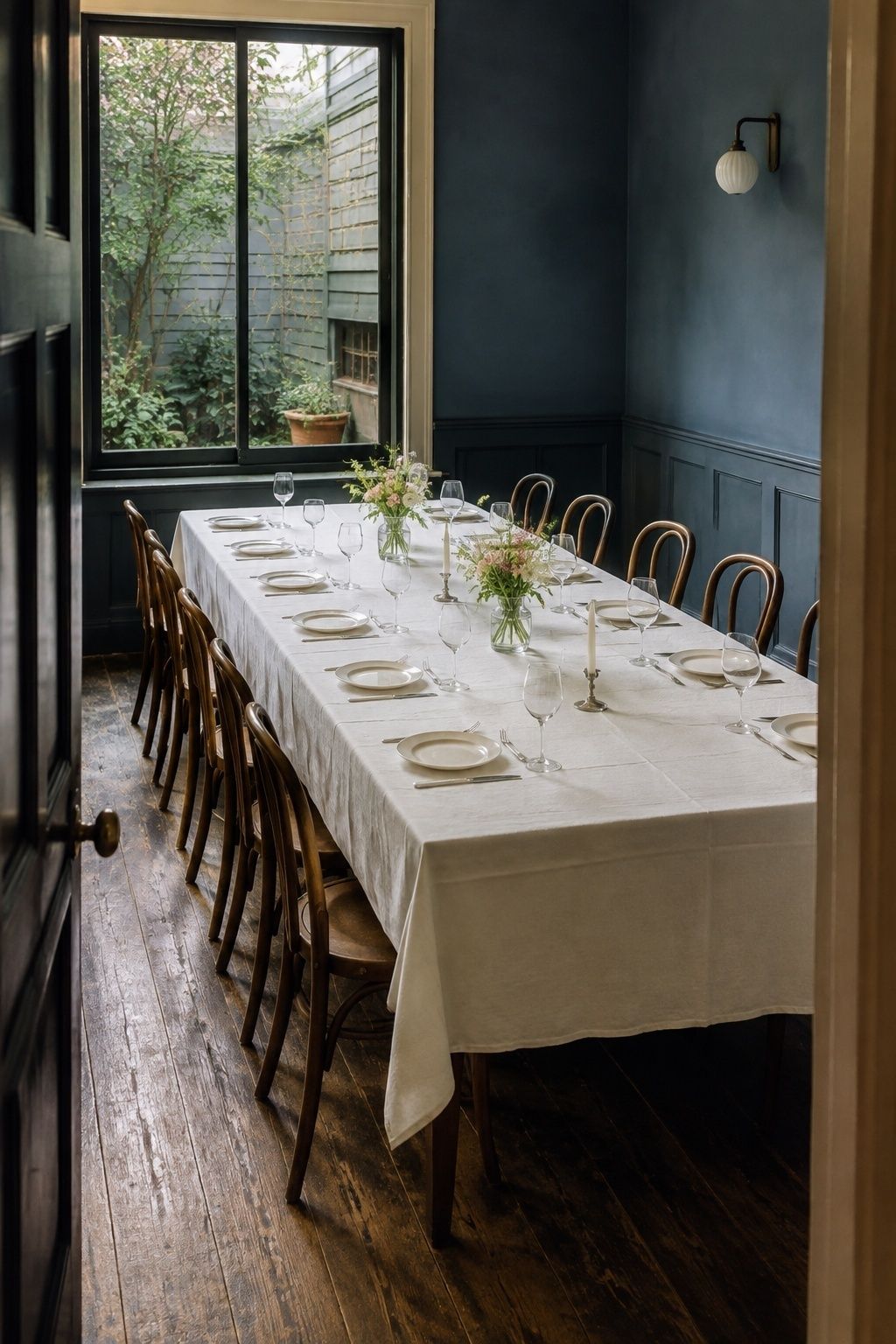 One shared wedding table in a small blue restaurant dining room