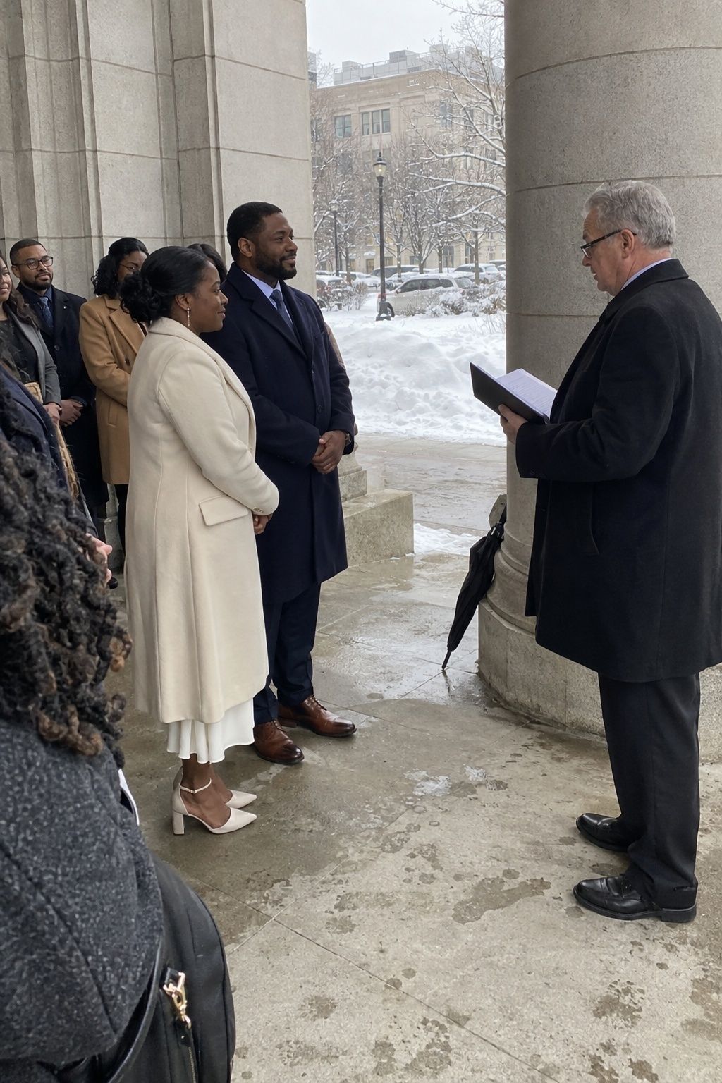 Focused small outdoor January wedding ceremony with bundled guests