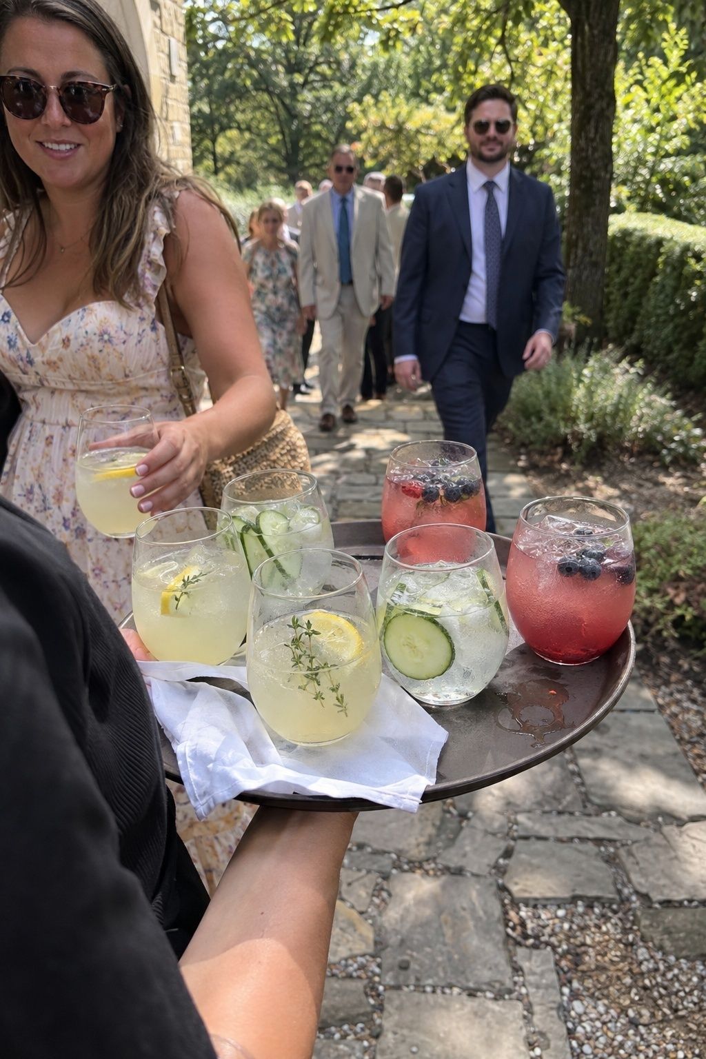 Cold lemonade and cucumber water offered to July wedding guests on arrival