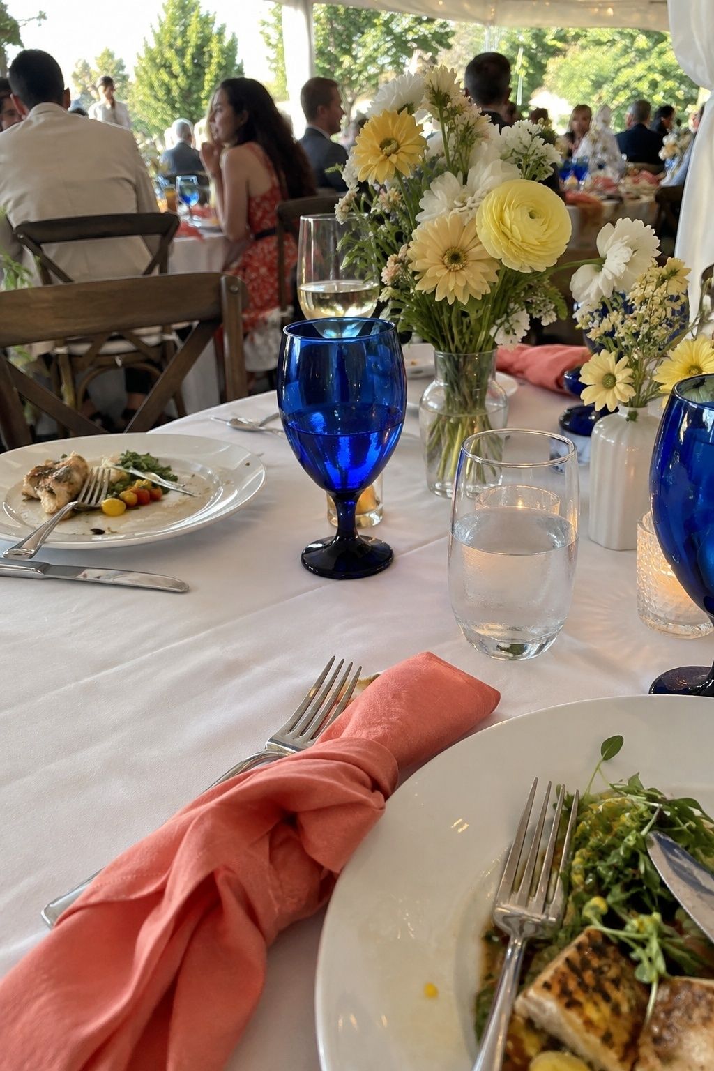 Coral, butter yellow, cobalt, and white July wedding tablescape