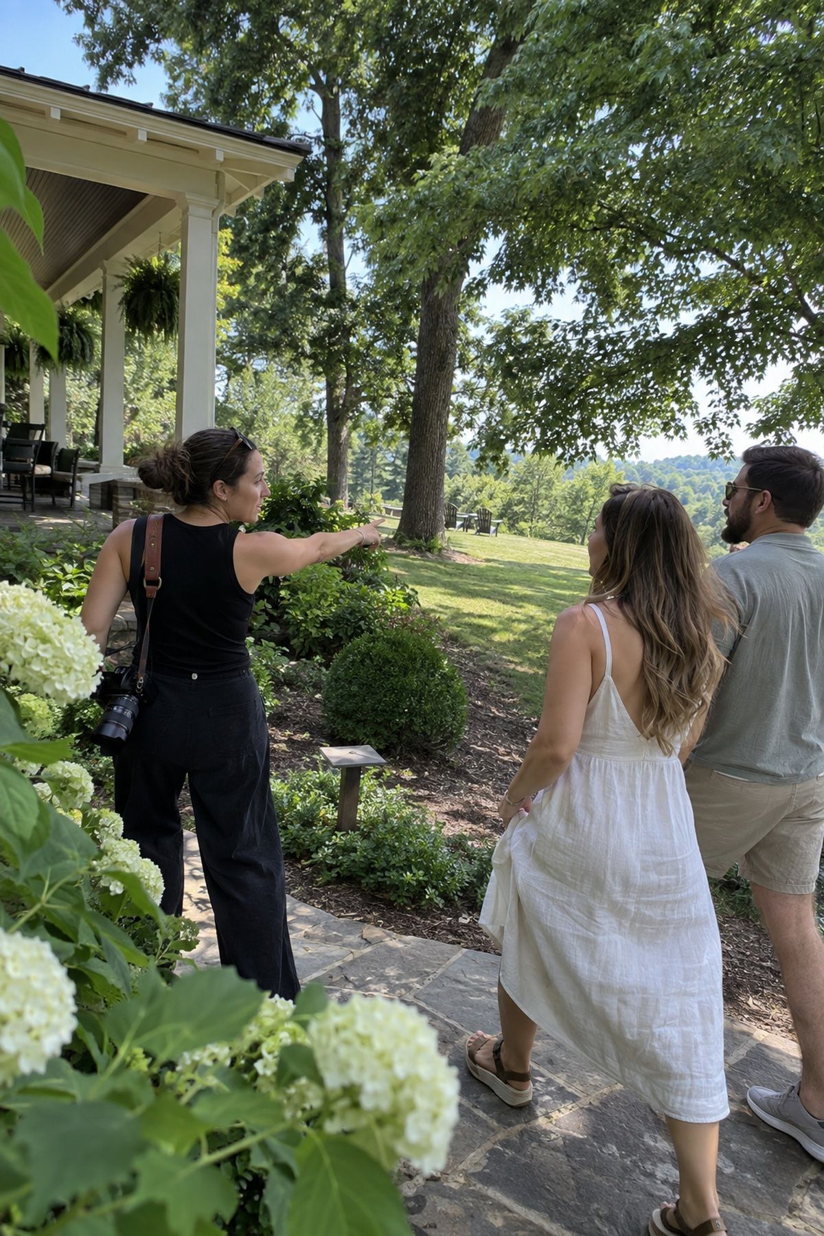 A couple and photographer scout shaded July wedding portrait locations before finalizing the timeline.