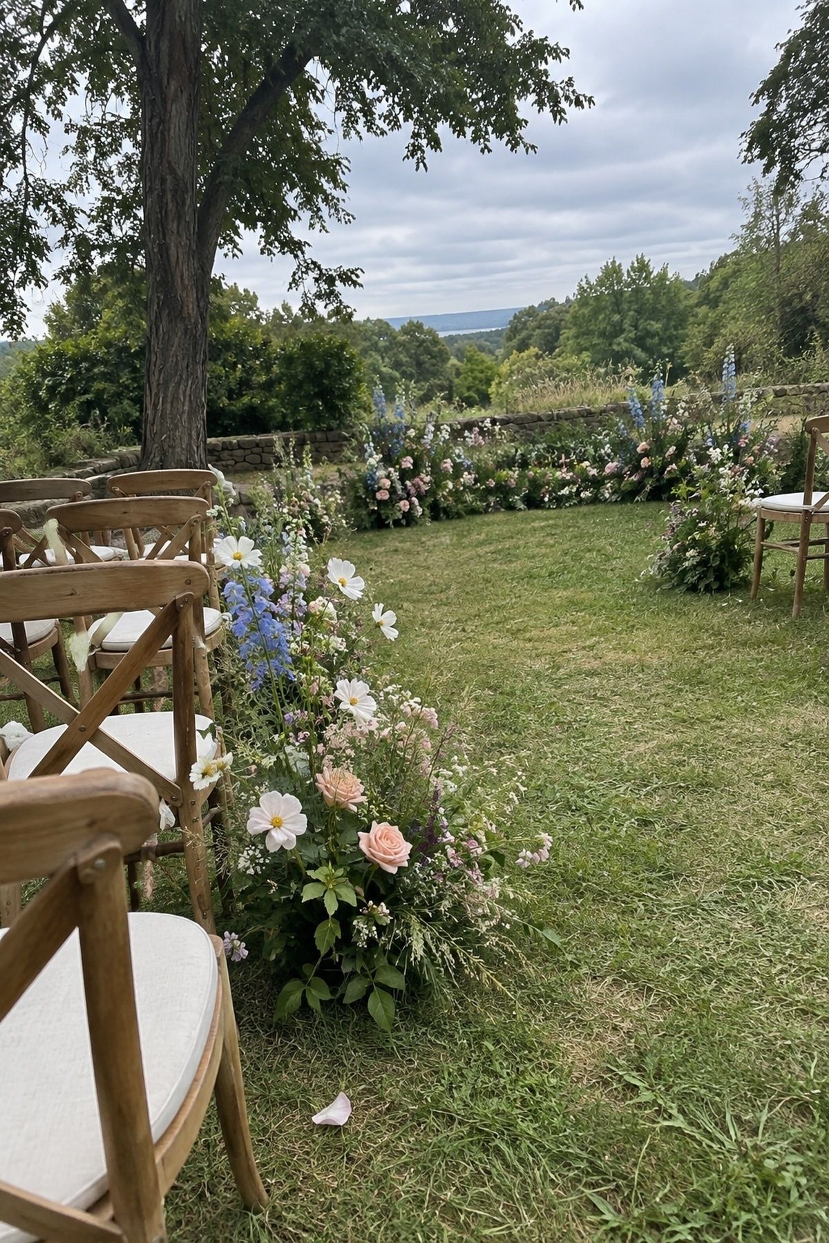 Grounded meadow-style June wedding flowers framing an open outdoor ceremony aisle.