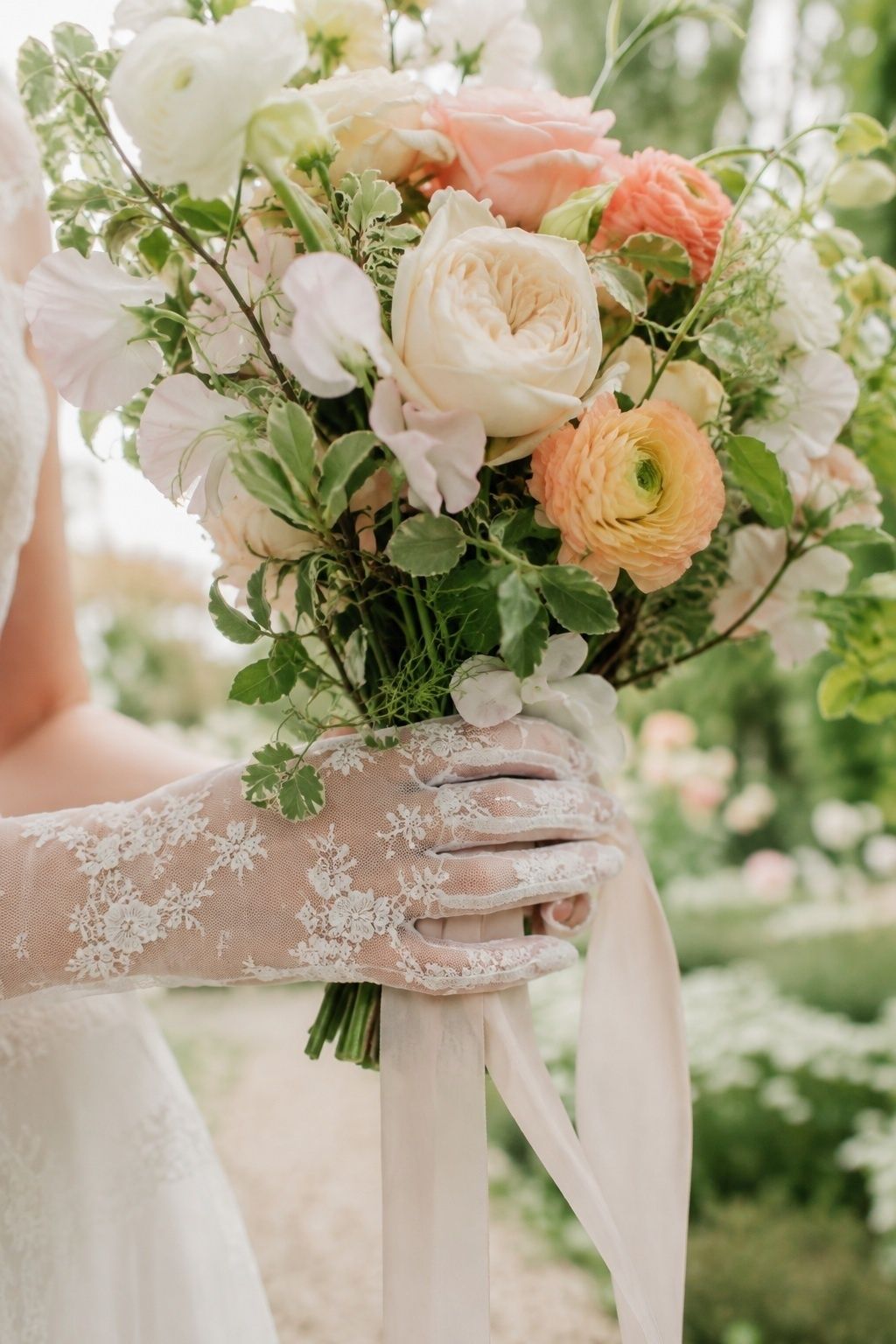 Floral lace gloves holding a garden bouquet