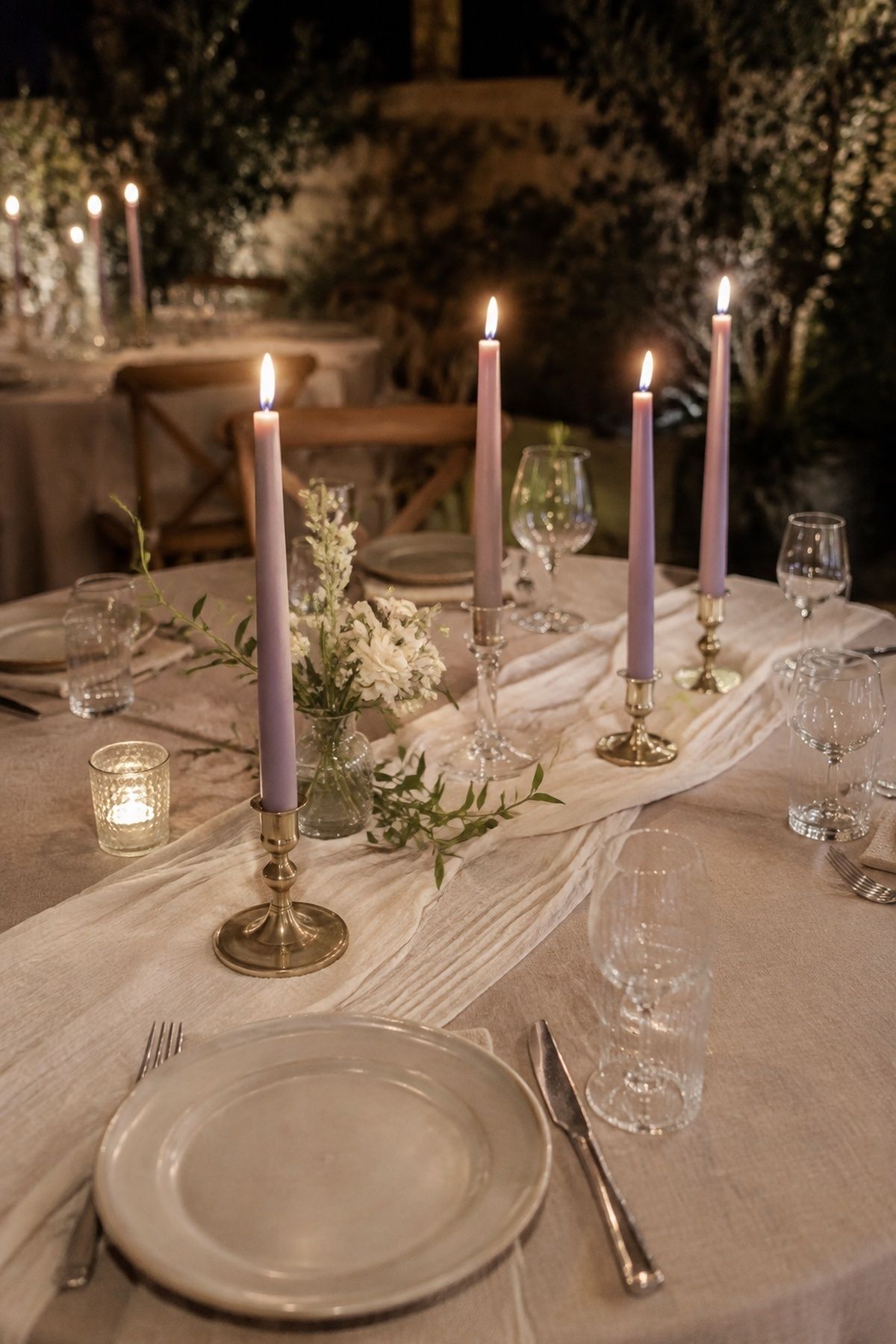 Lavender taper candles on neutral linens