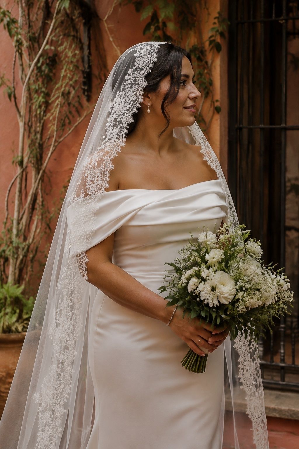 Lace mantilla framing a plain off-shoulder satin neckline
