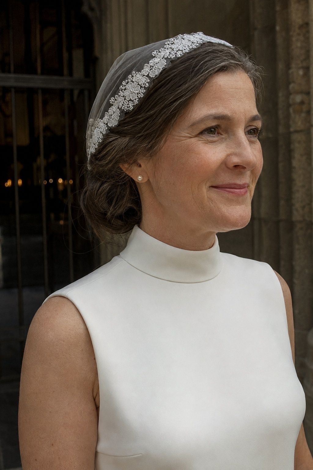 High mock-neck bridal gown paired with a fine lace mantilla