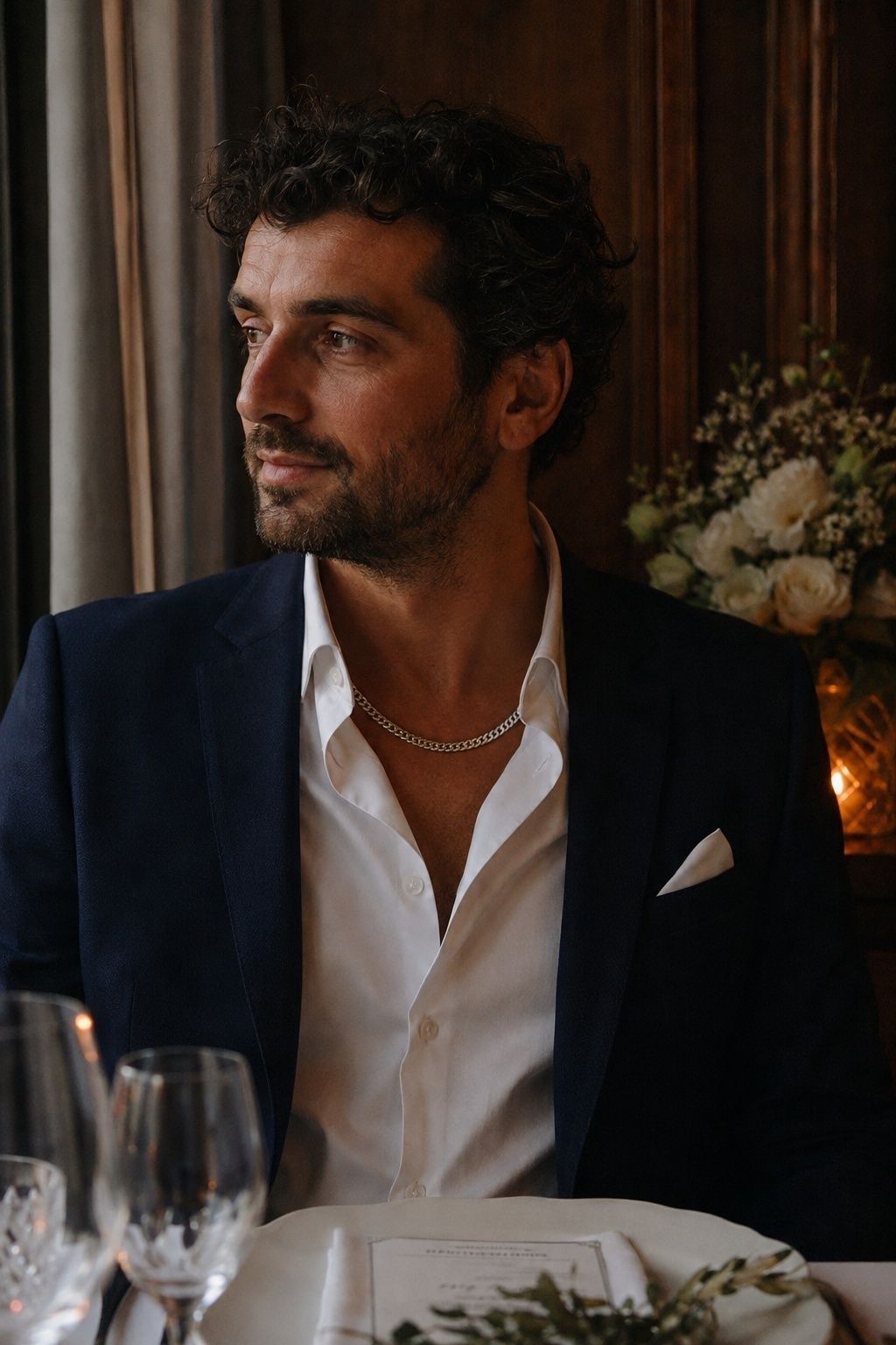 Medium silver curb chain against an open white shirt and midnight dinner jacket at a restaurant reception