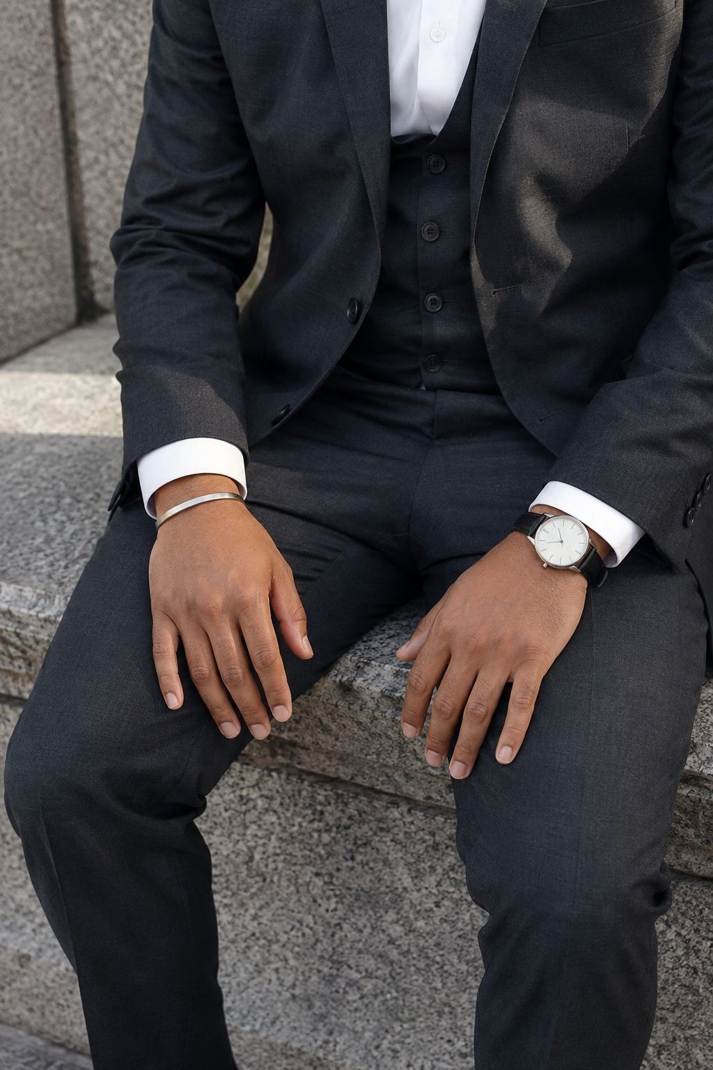 Silver bracelet worn opposite the watch wrist