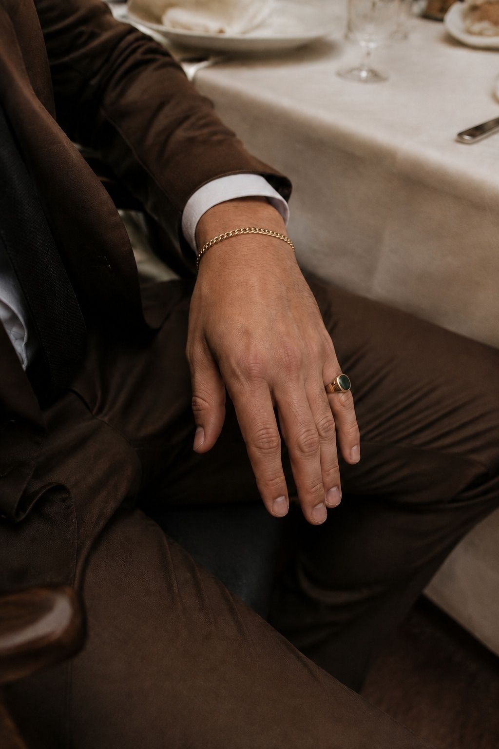 Groom's bracelet and pinky ring styled with restraint