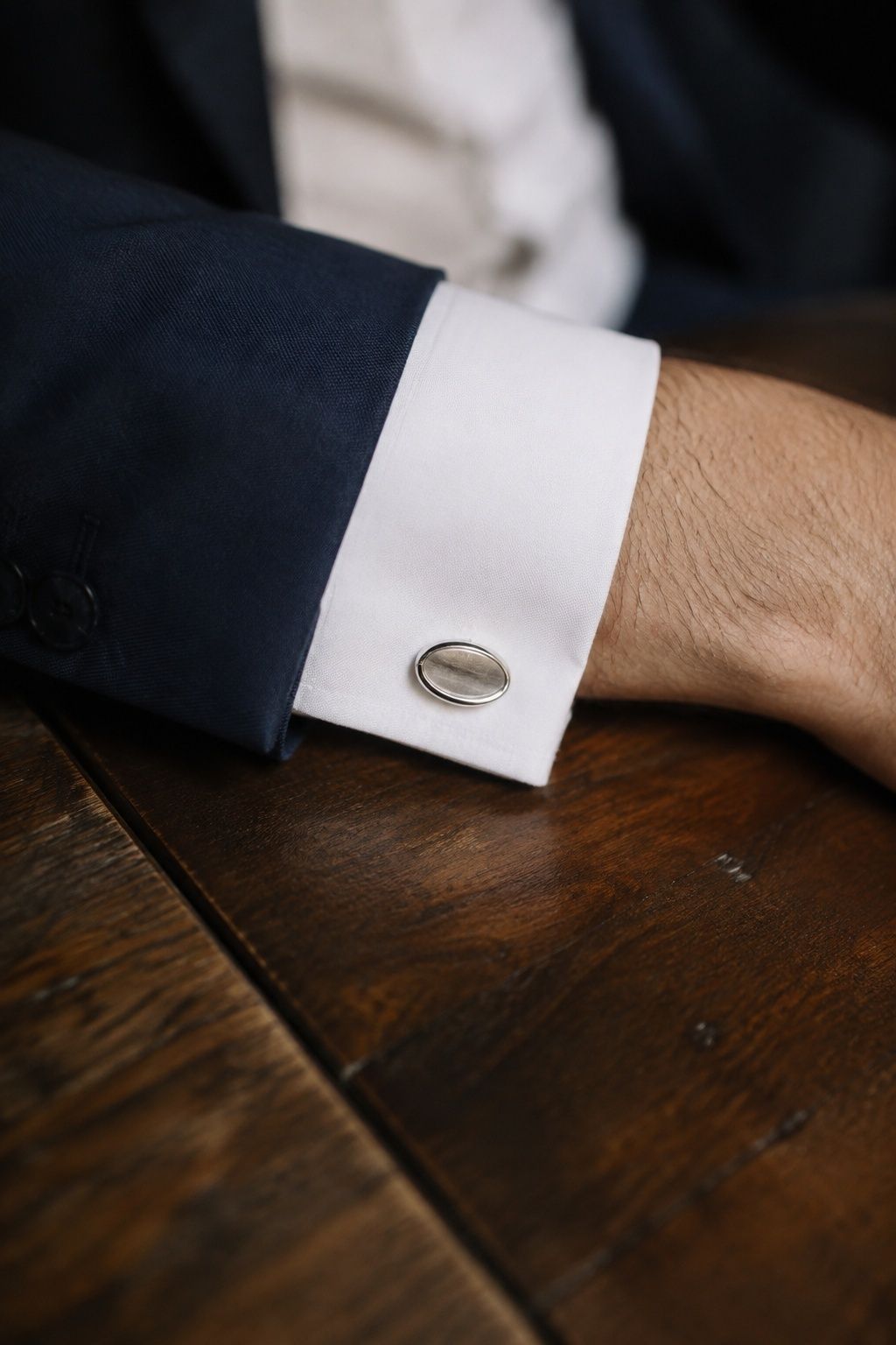 Silver cufflinks on a groom's shirt