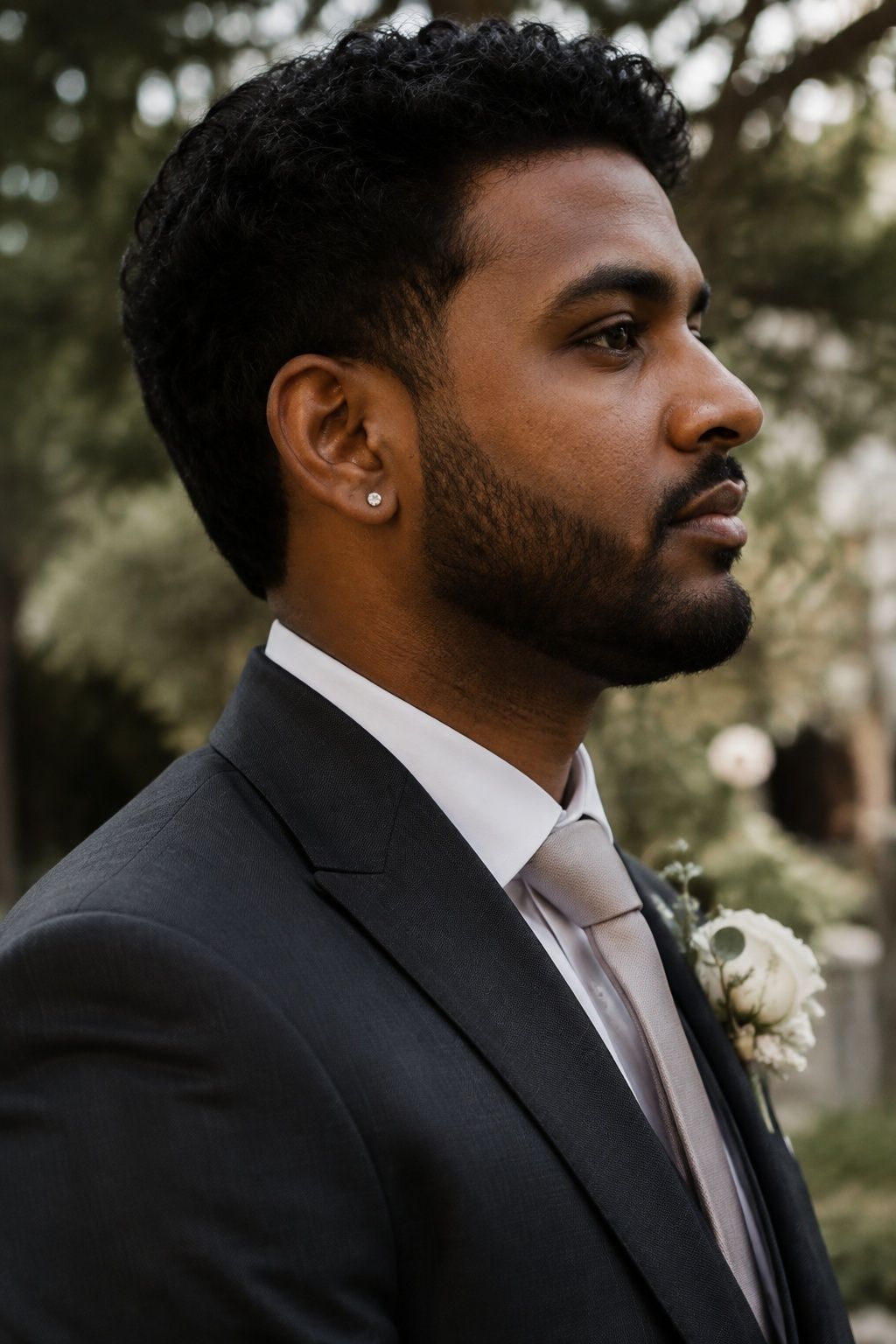 Tiny silver stud earrings for a groom