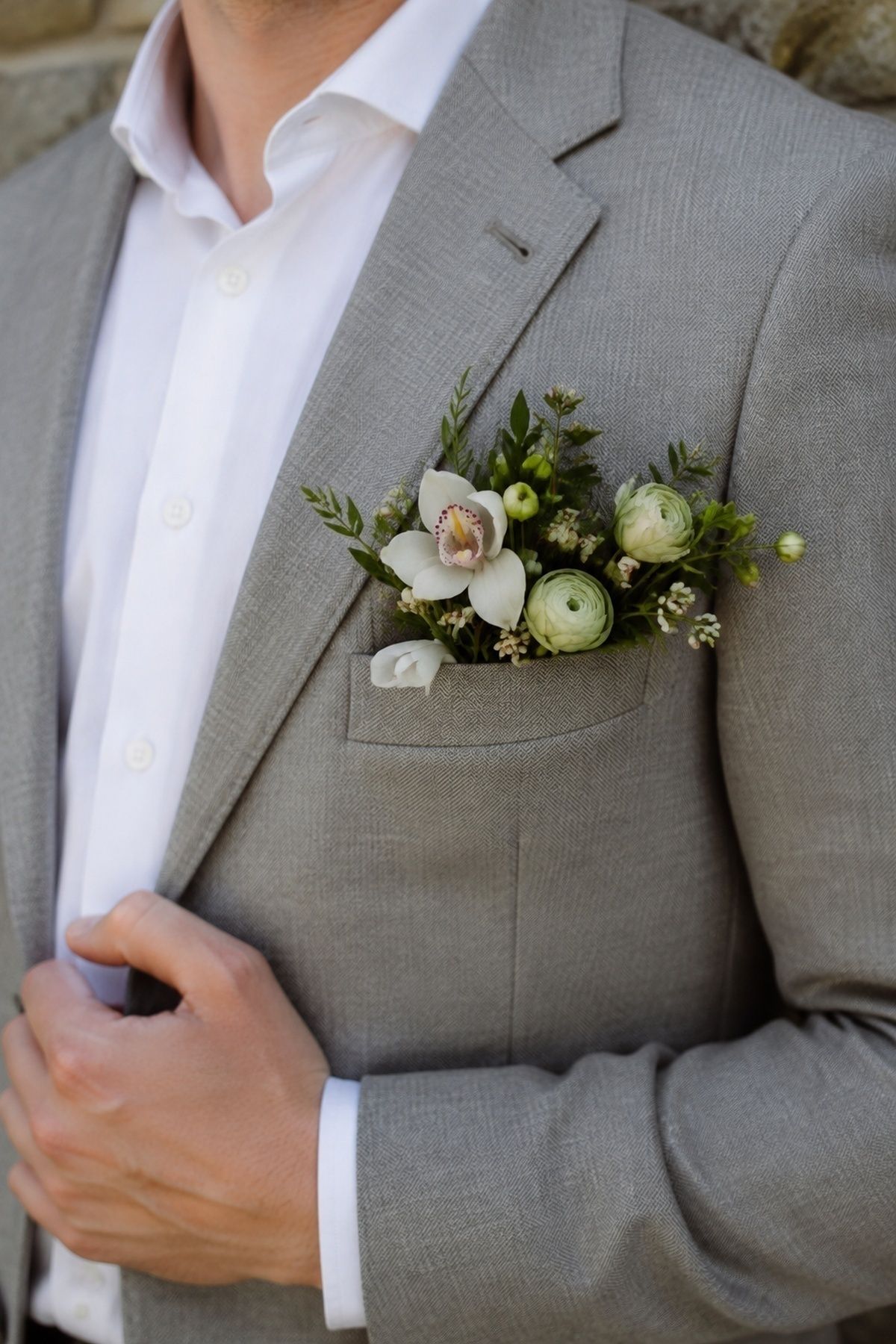 Pocket bouquet tucked into a tailored jacket