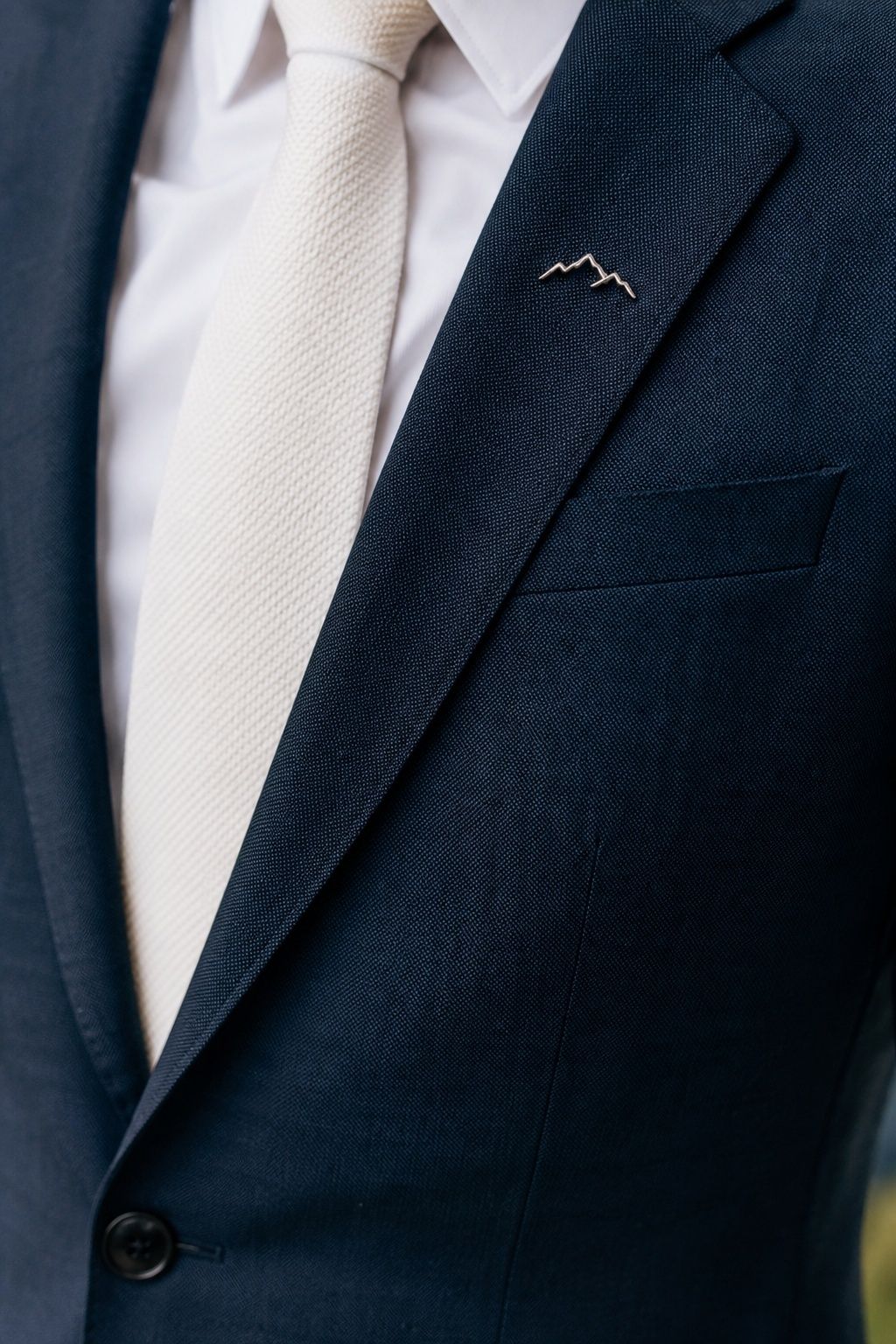 Groom's lapel pin with a meaningful motif