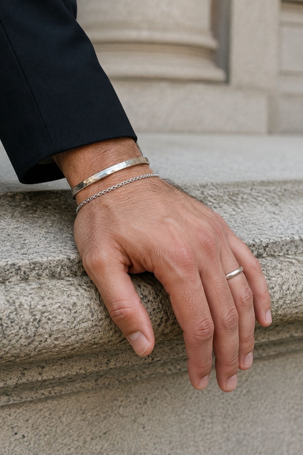 Mixed-texture silver jewellery stack in close-up