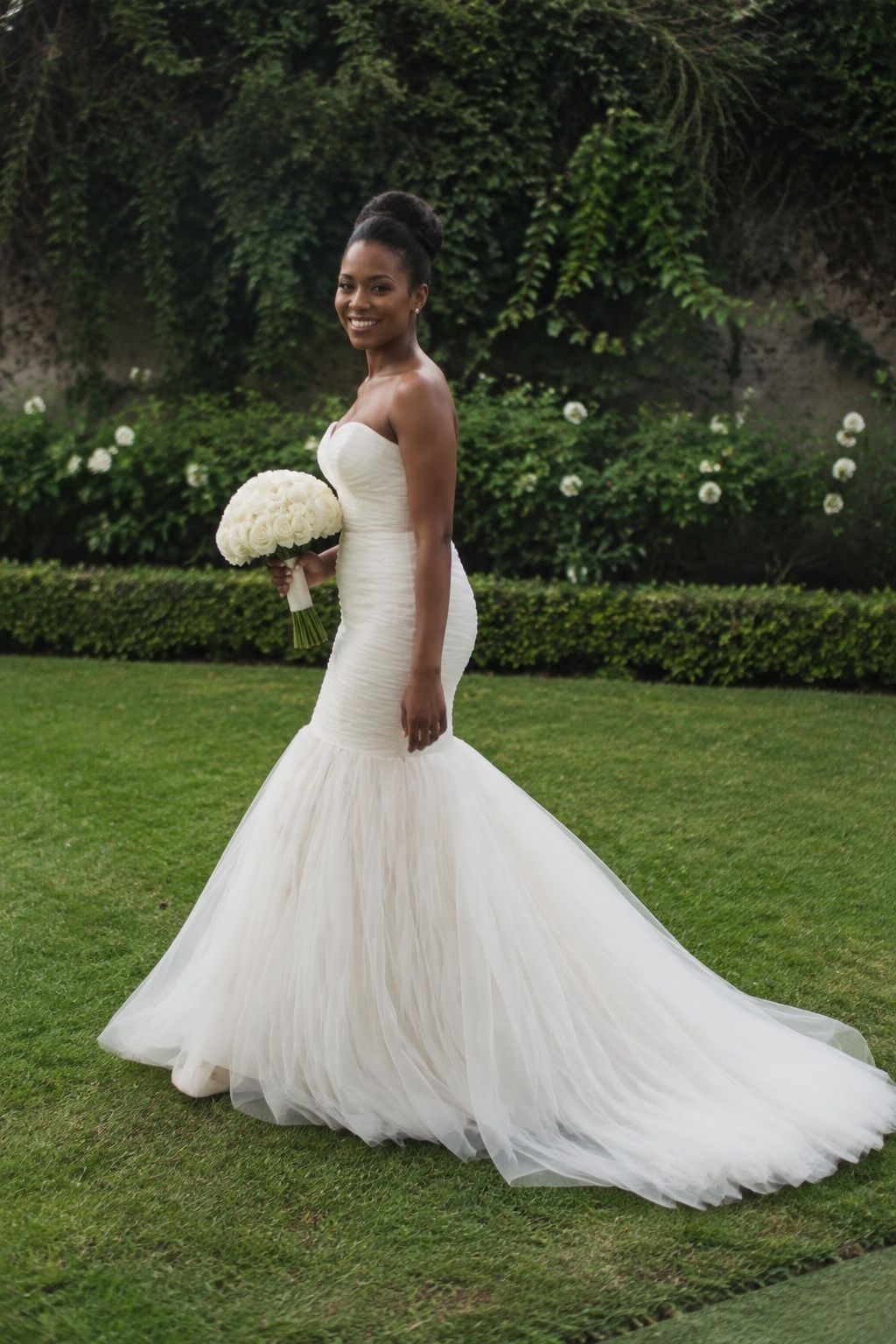 Gathered waist transitioning gradually into an airy tulle mermaid skirt in a garden.