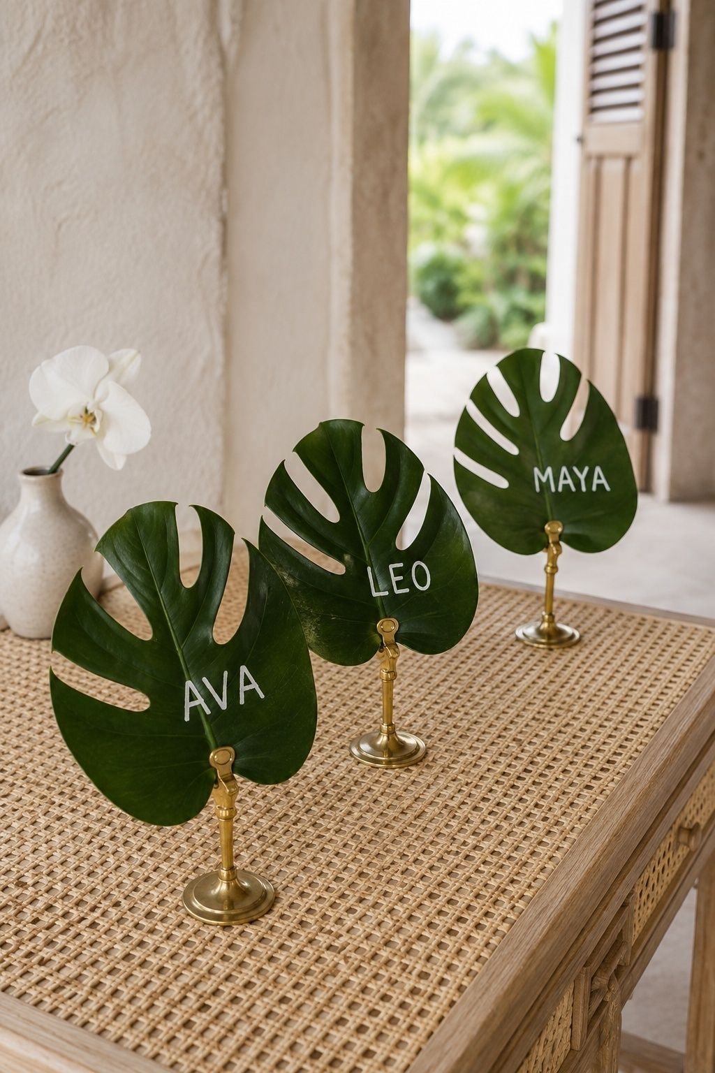 Escort cards on monstera leaves