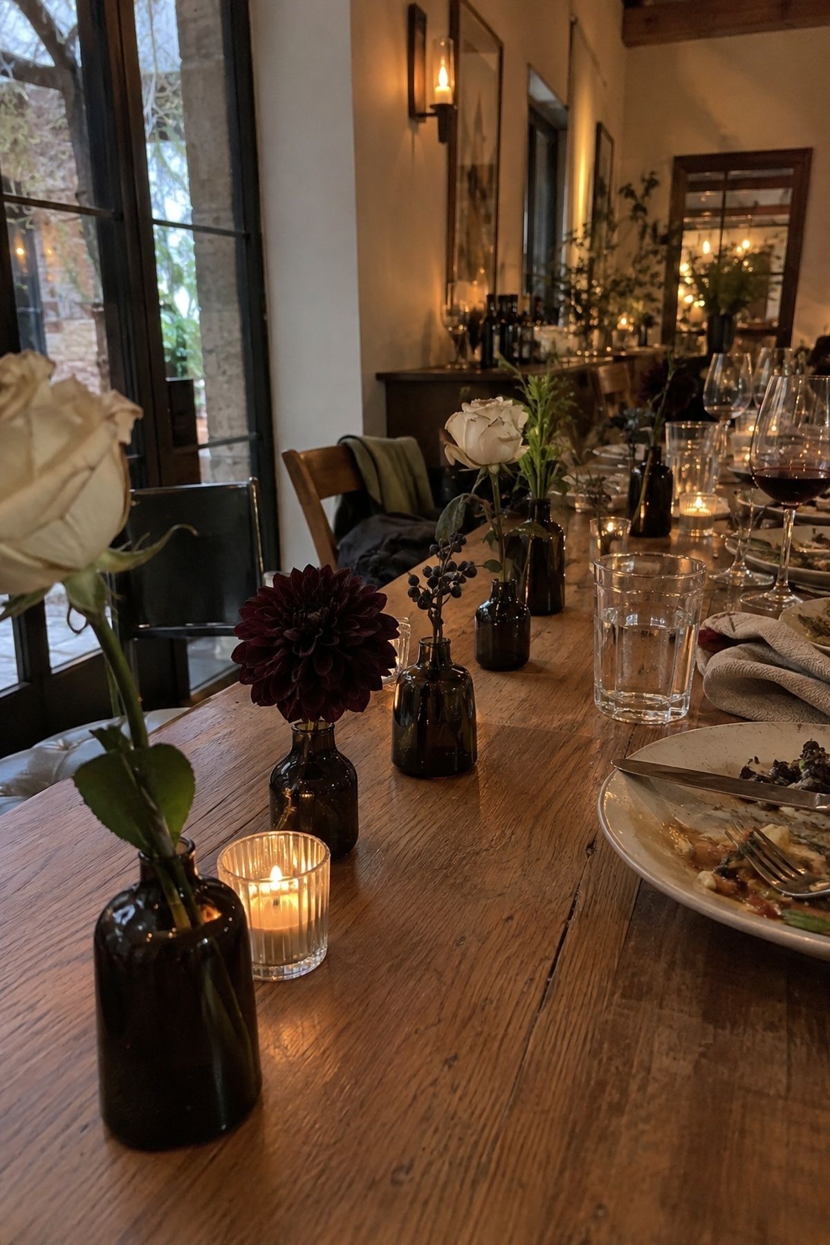 Dark bud vases on small tables