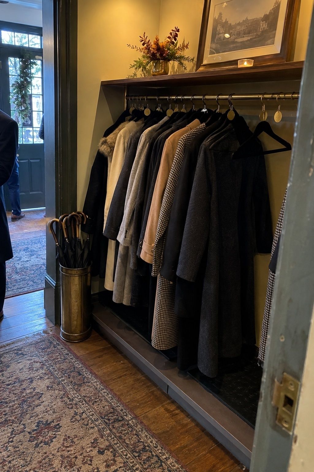 Designed November wedding coat check with wool coats and umbrellas.