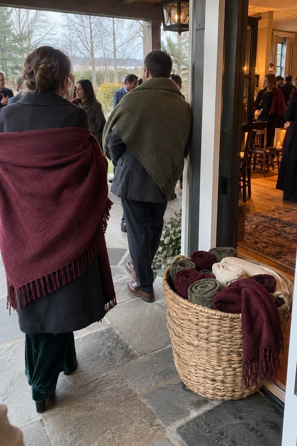 Wedding guests using warm blankets during an outdoor November transition.