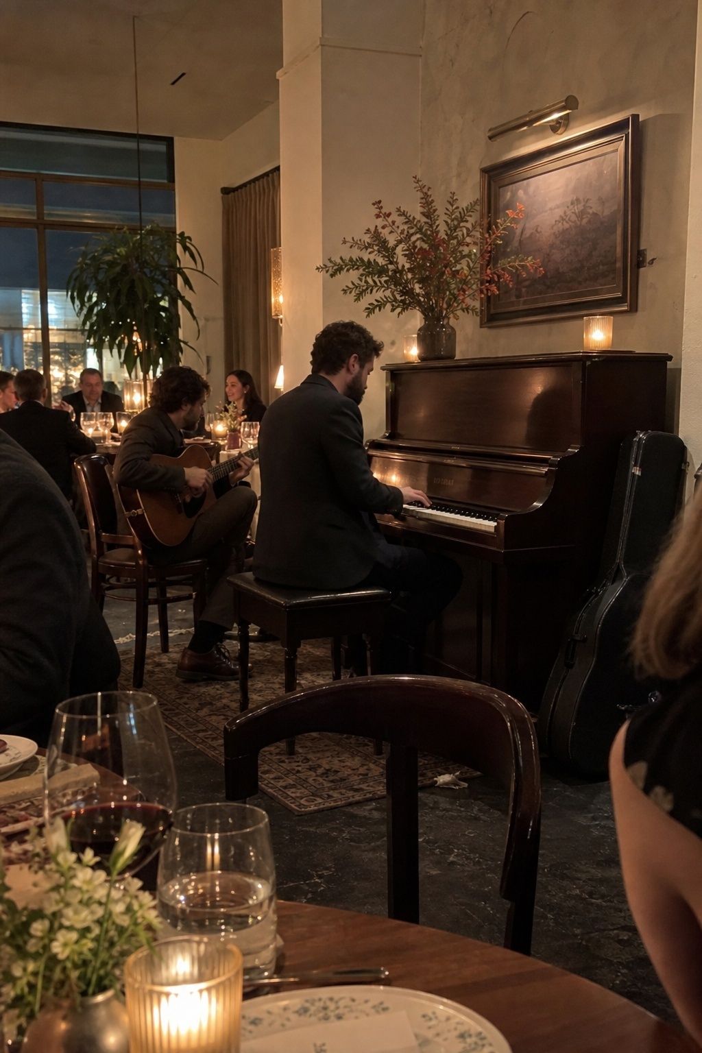 Acoustic guitarist and pianist playing during a cozy wedding dinner.