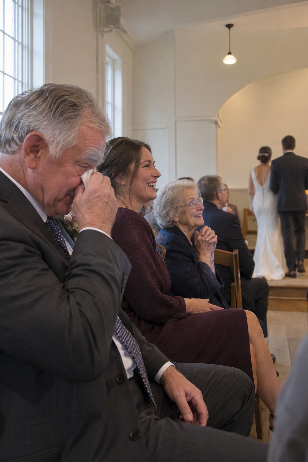 Three generations react with tears and laughter just after the November wedding vows.