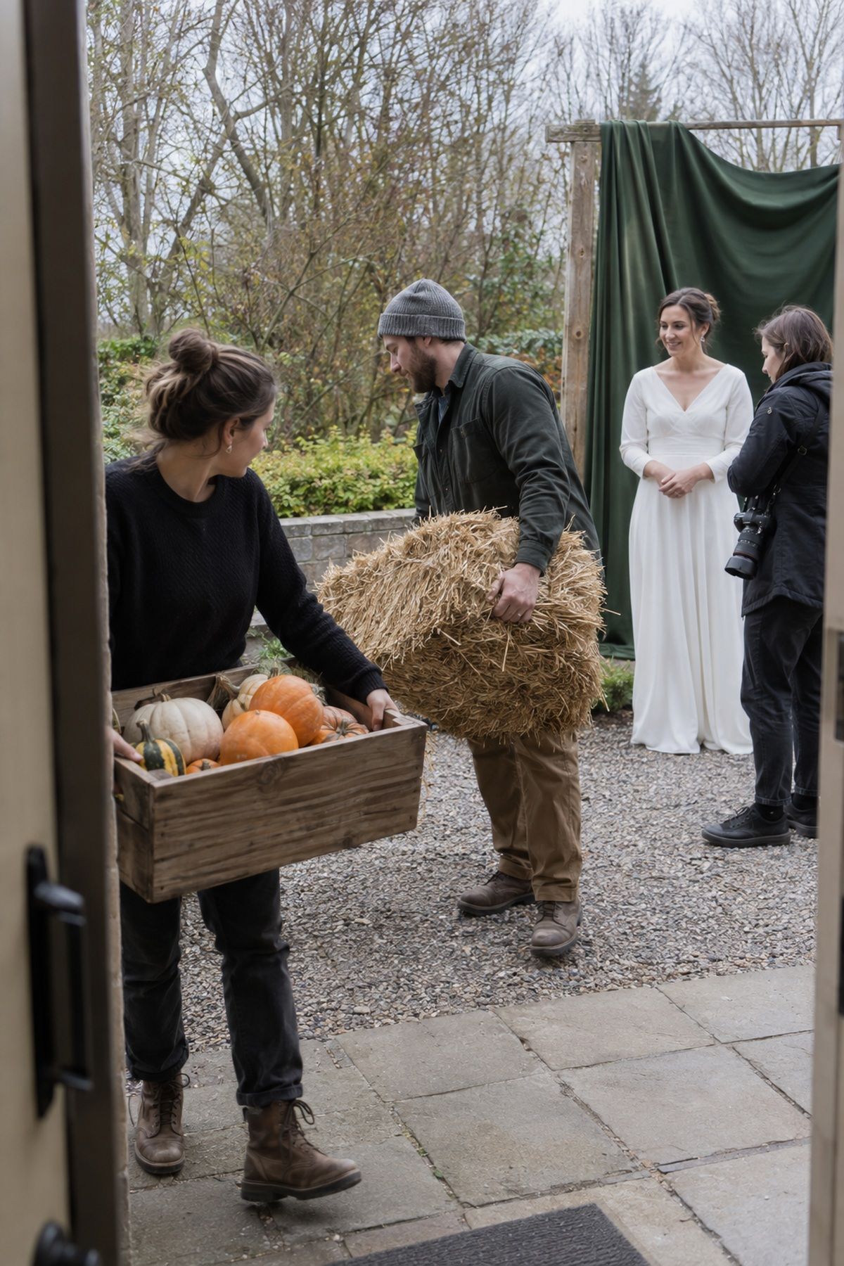 Wedding helpers remove extra autumn props from a restrained November portrait corner.
