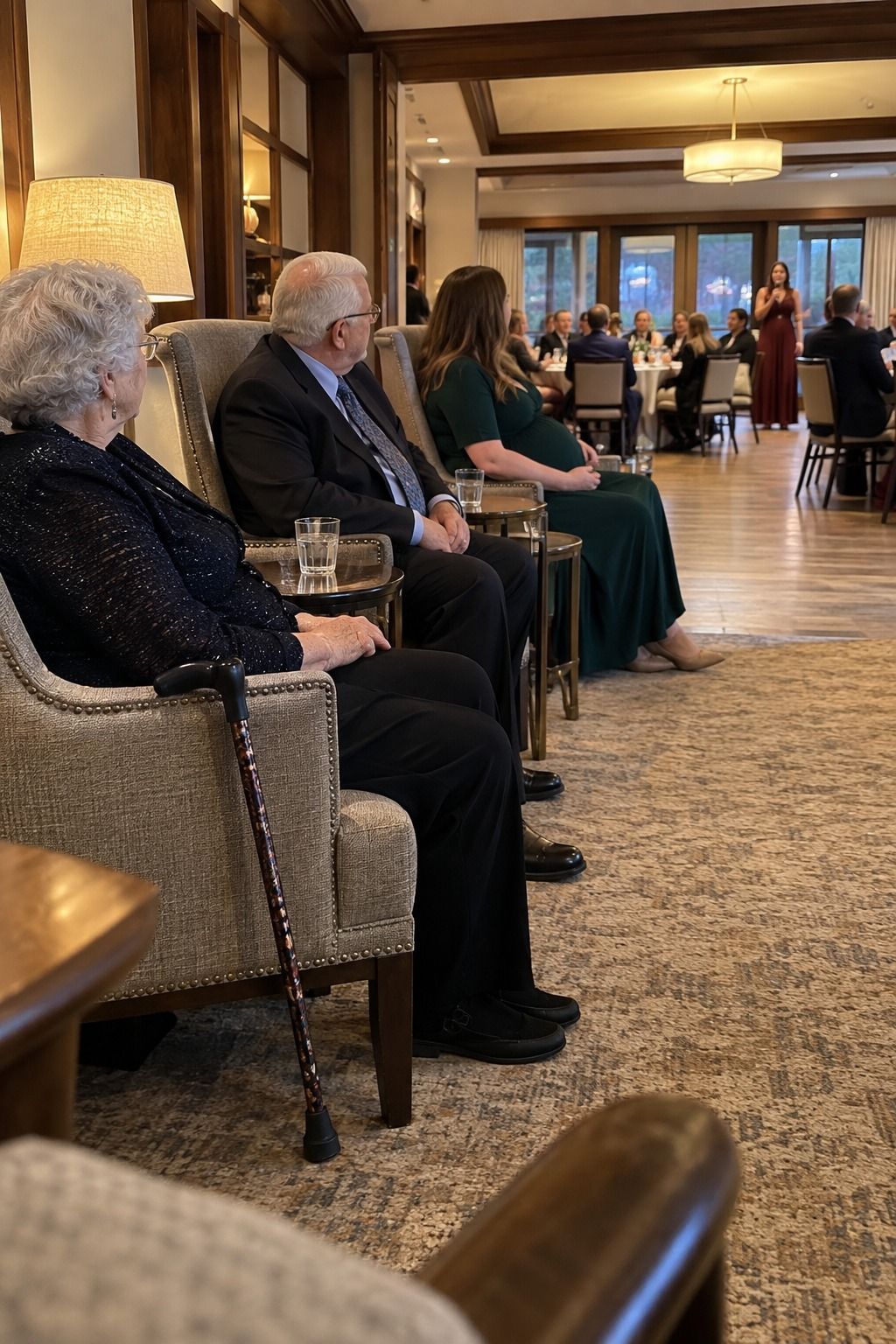 Supportive chairs, a clear aisle, and nearby water keep older guests connected to the reception.